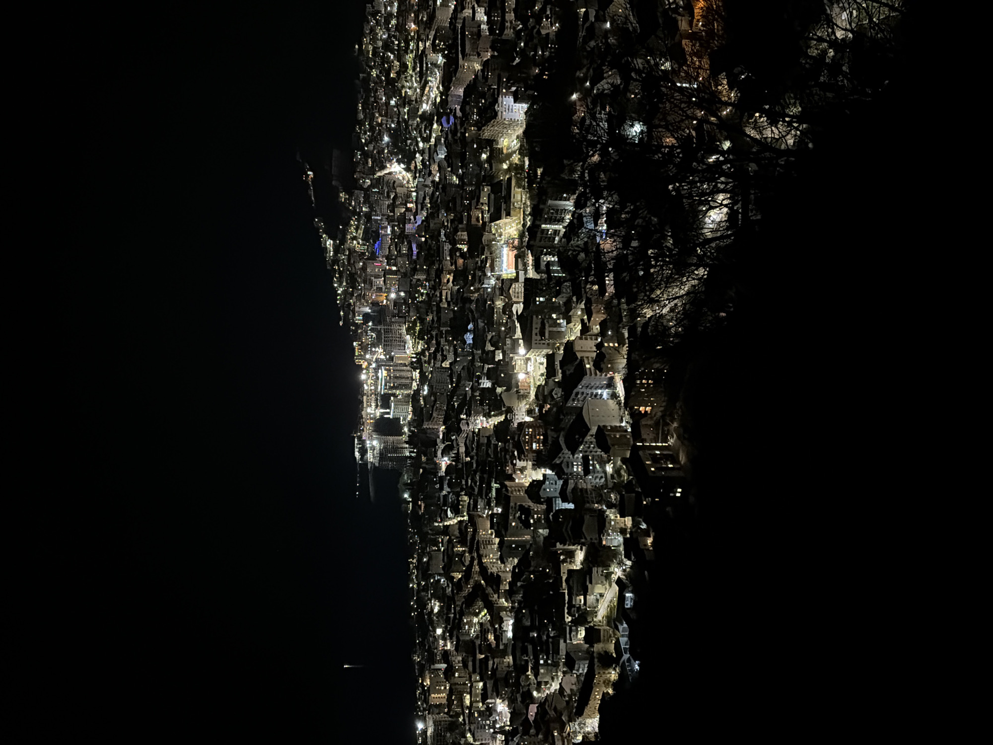 Nighttime aerial view captures illuminated Budva, Montenegro cityscape