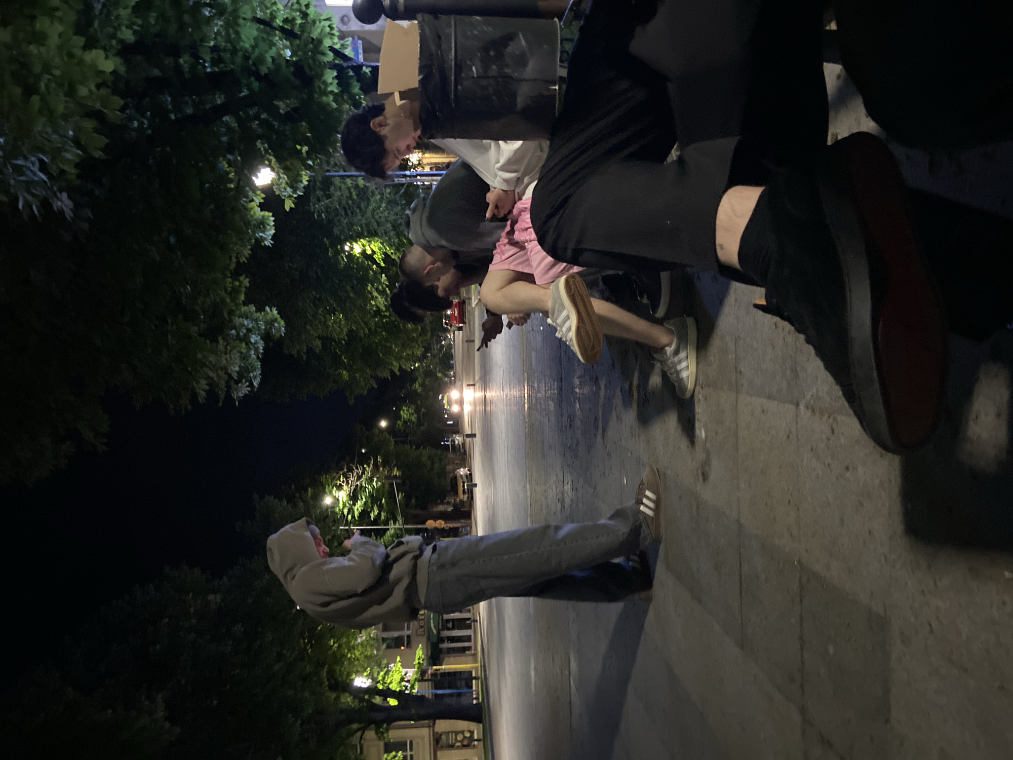 Young people gather on nighttime street in Ruse, Bulgaria