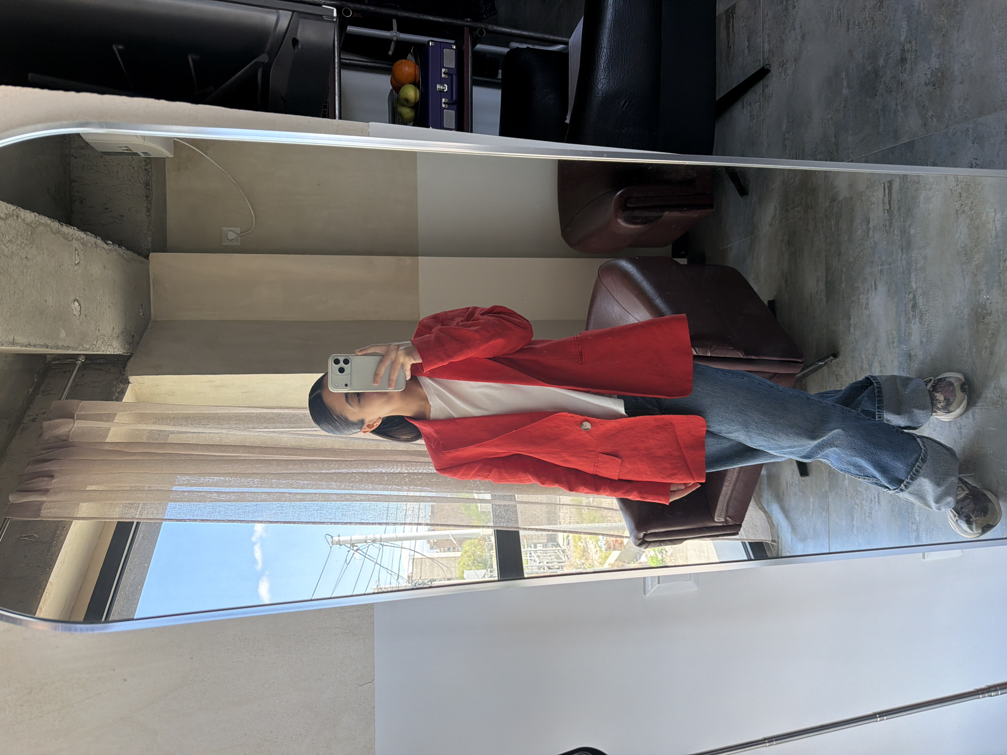 Person takes mirror selfie in white shirt, red blazer in Yerevan