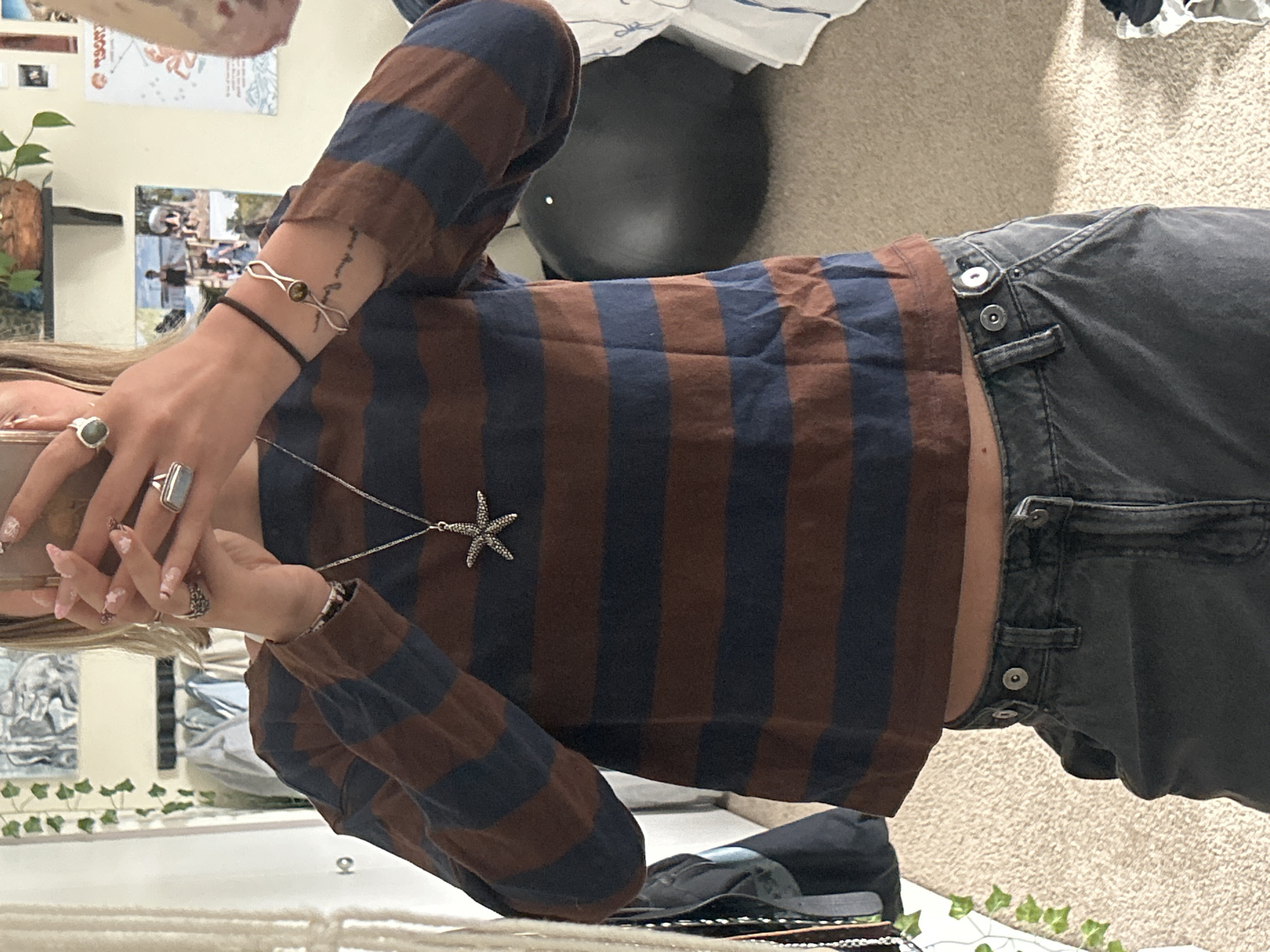 Person photographed indoors wearing distinctive jewelry in Whistler