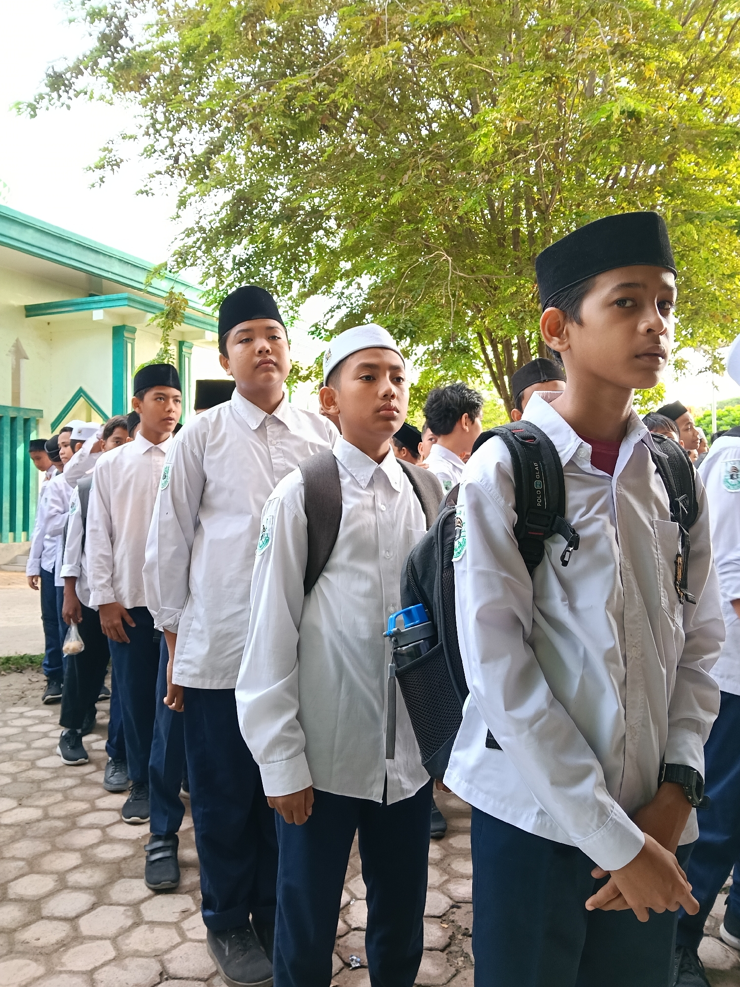 Students queue outside building in Lhokseumawe, Indonesia