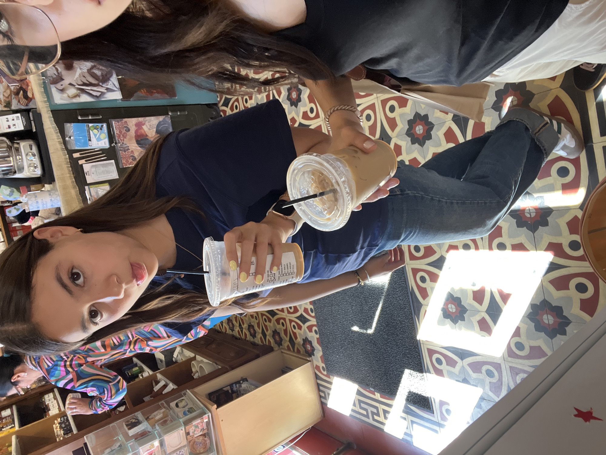 Woman enjoys iced coffee at Fredericksburg shop