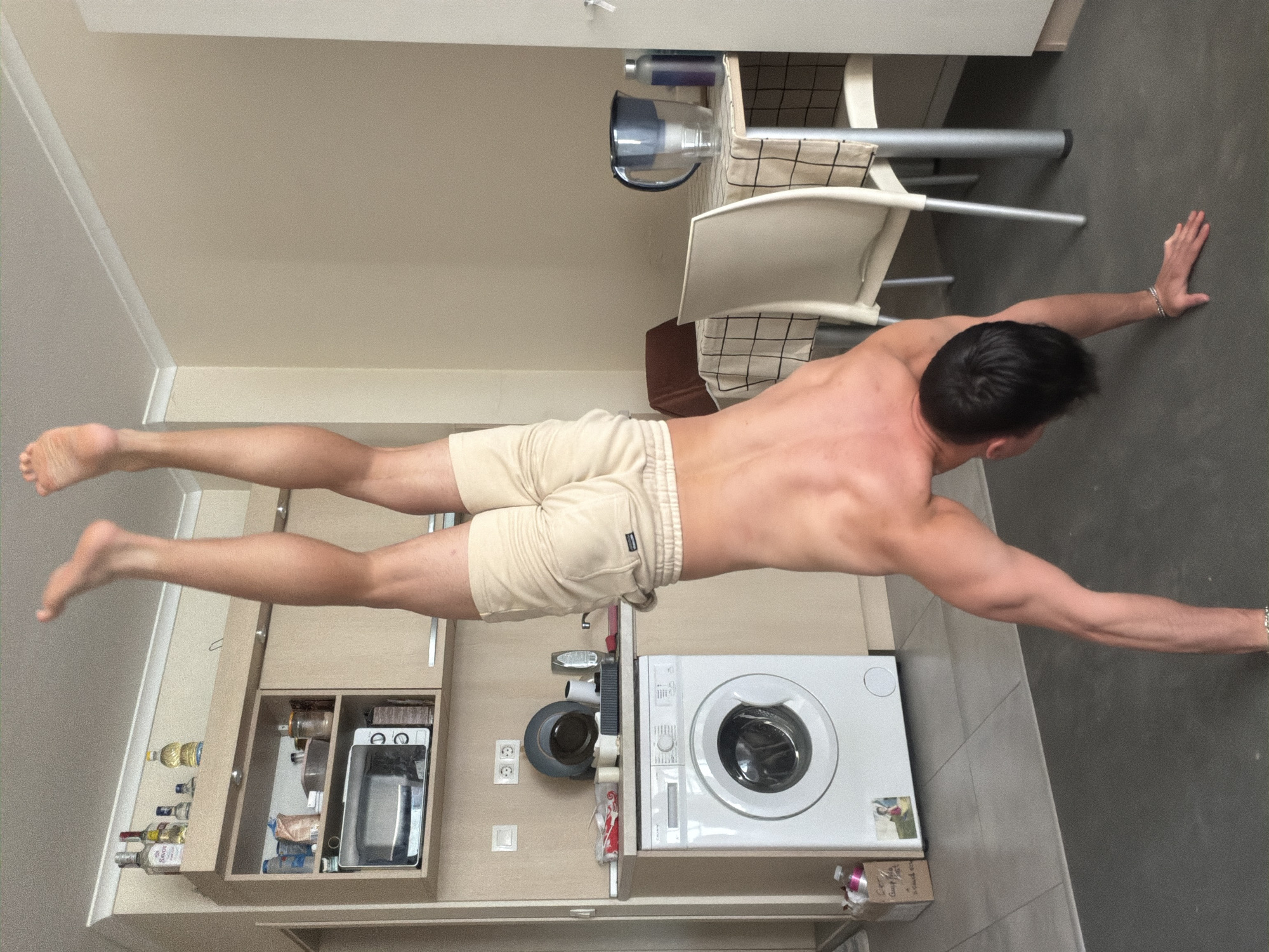 Man performs calisthenics workout routine in Sofia apartment kitchen