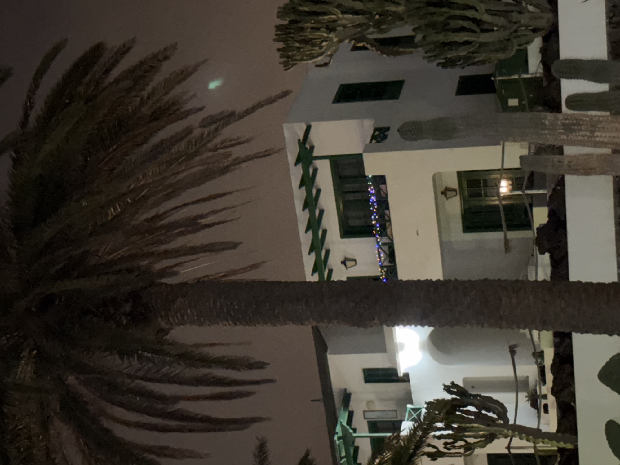 White building with green trim photographed in Puerto Del Carmen