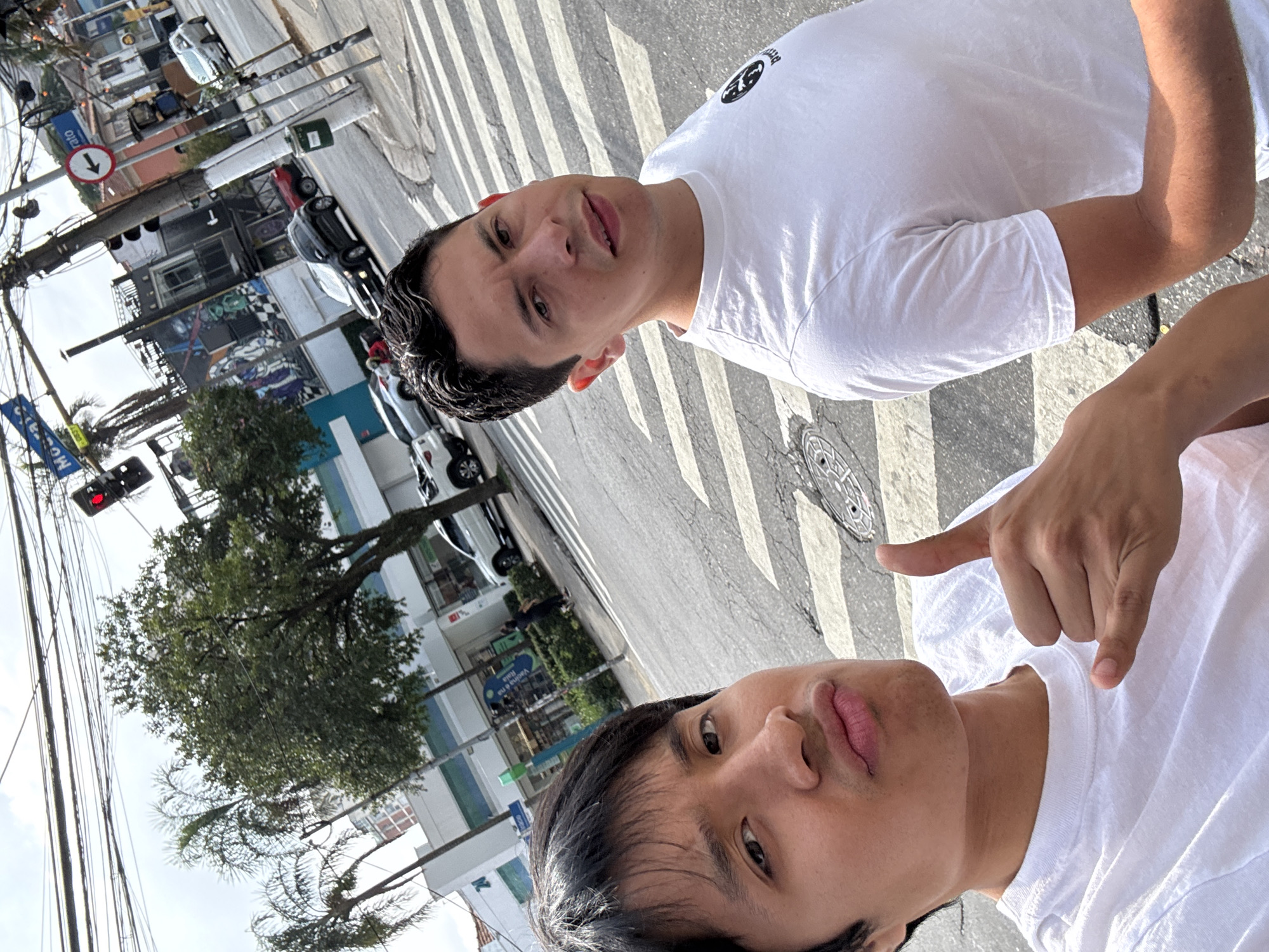 Young men take street selfie in downtown São Paulo