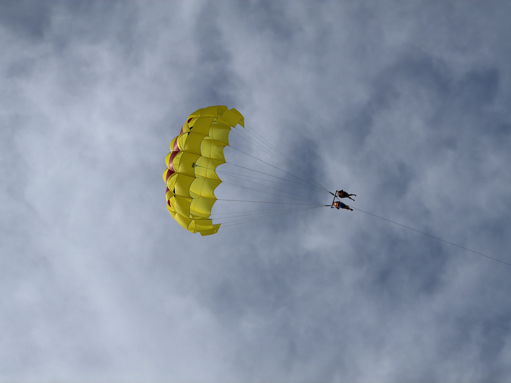 Two parasail under cloudy skies in Serik, Turkey
