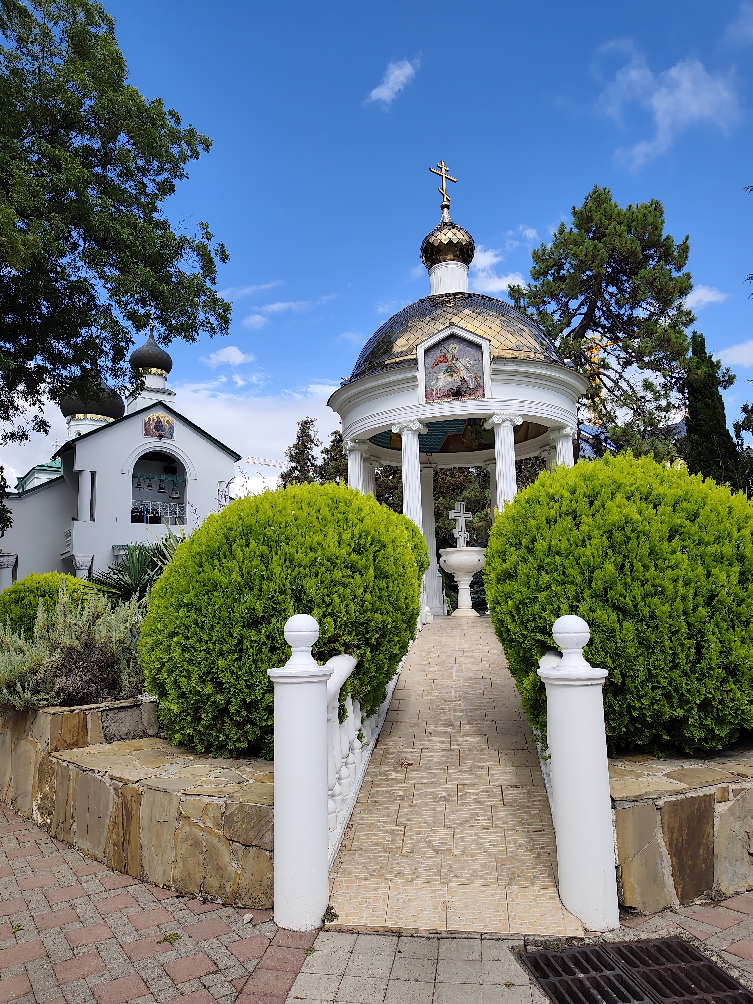 White church and golden rotunda in Sochi's summer greenery