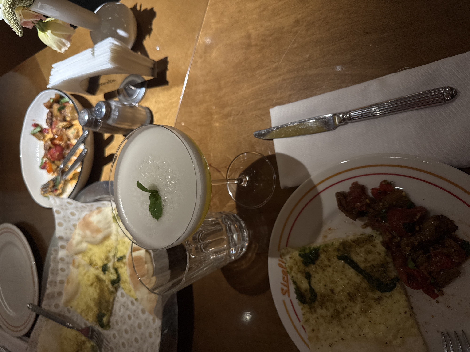 Herb-topped flatbread and drinks at a Yerevan restaurant table
