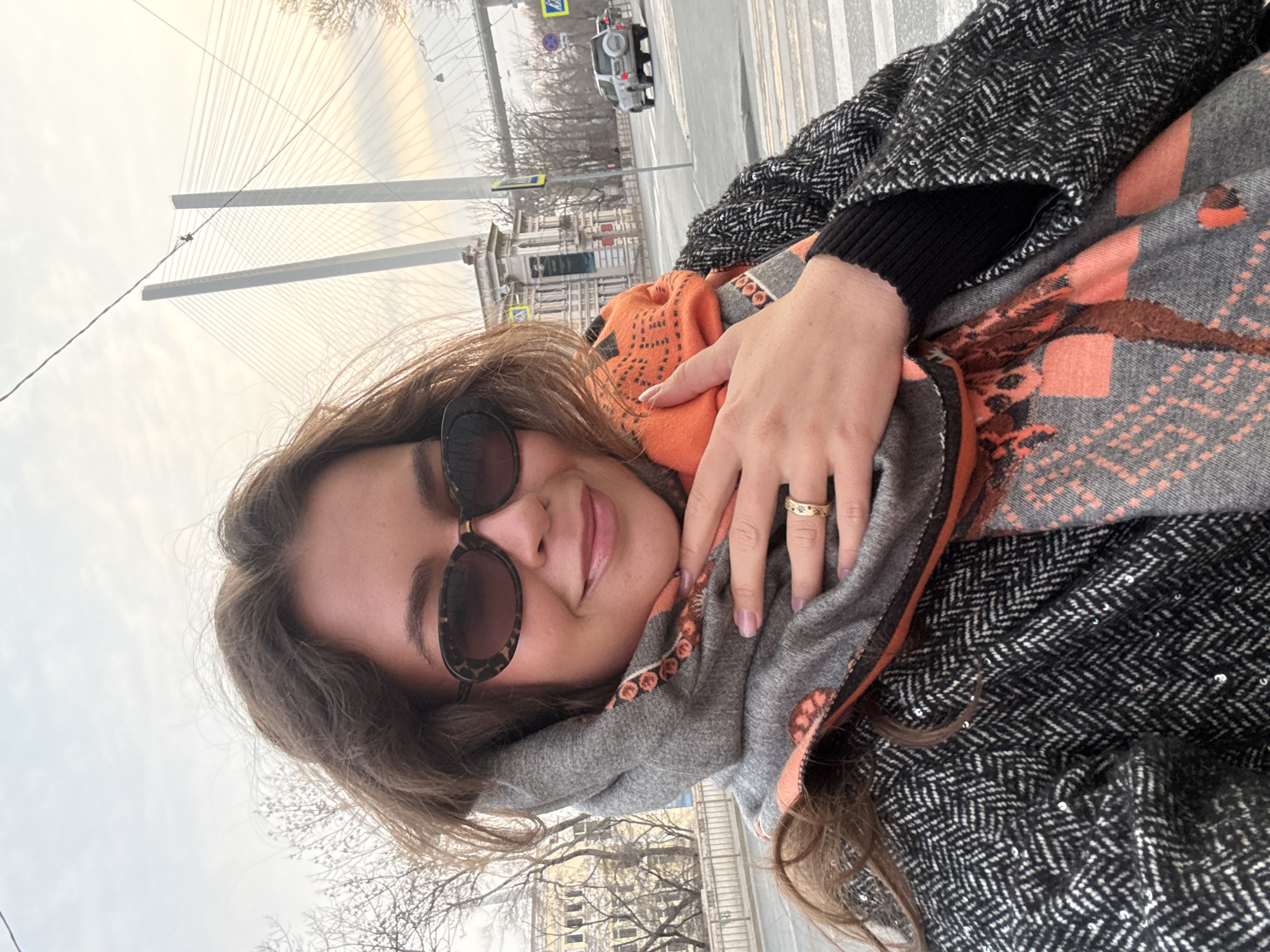 Woman takes selfie in Vladivostok wearing patterned scarf
