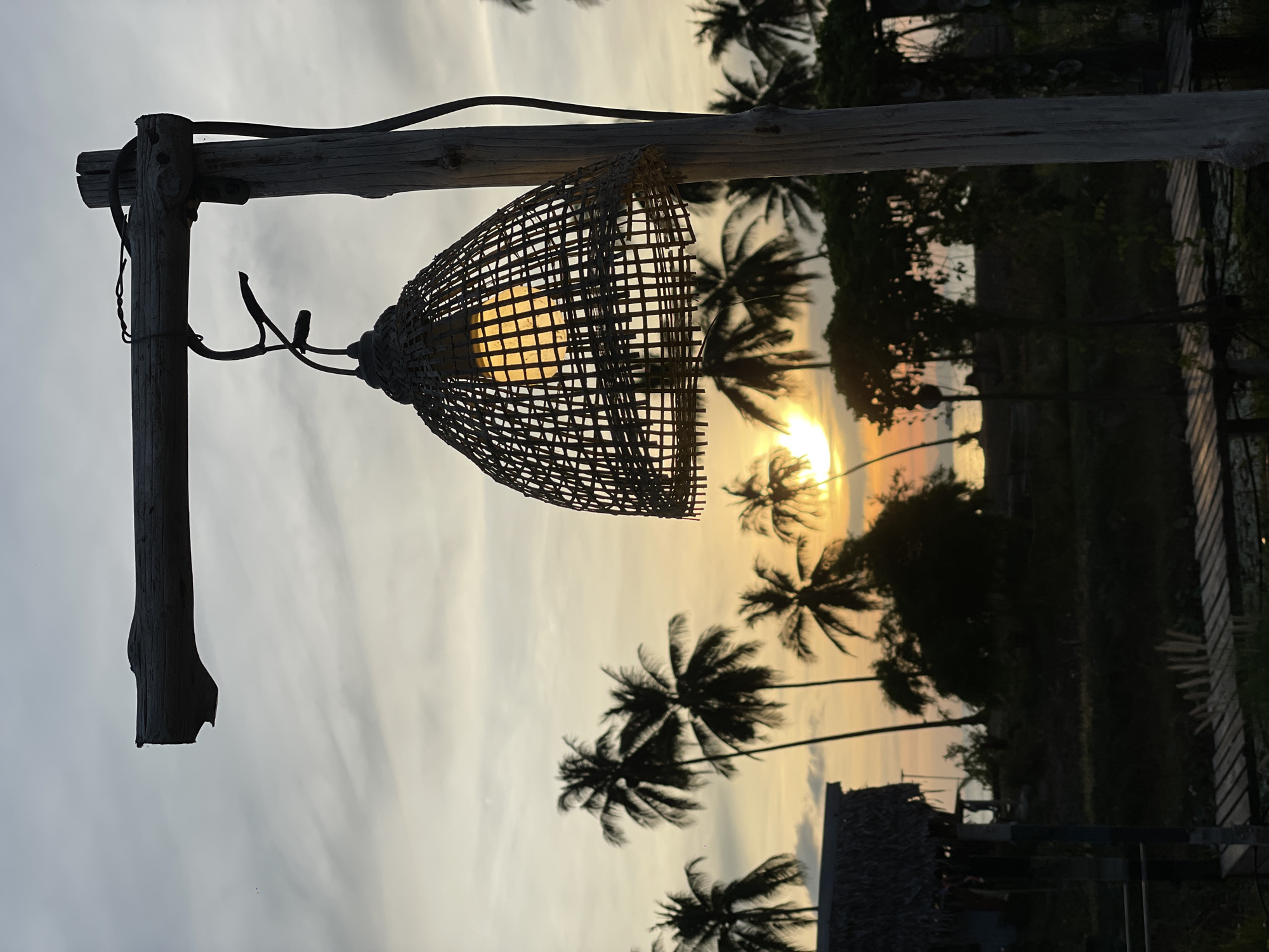 Sunset and recycled art captured at Thai beachfront location