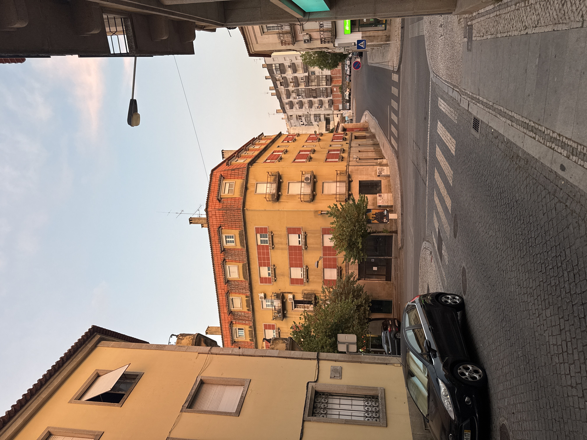Castelo Branco streets glow under a summer evening sunset