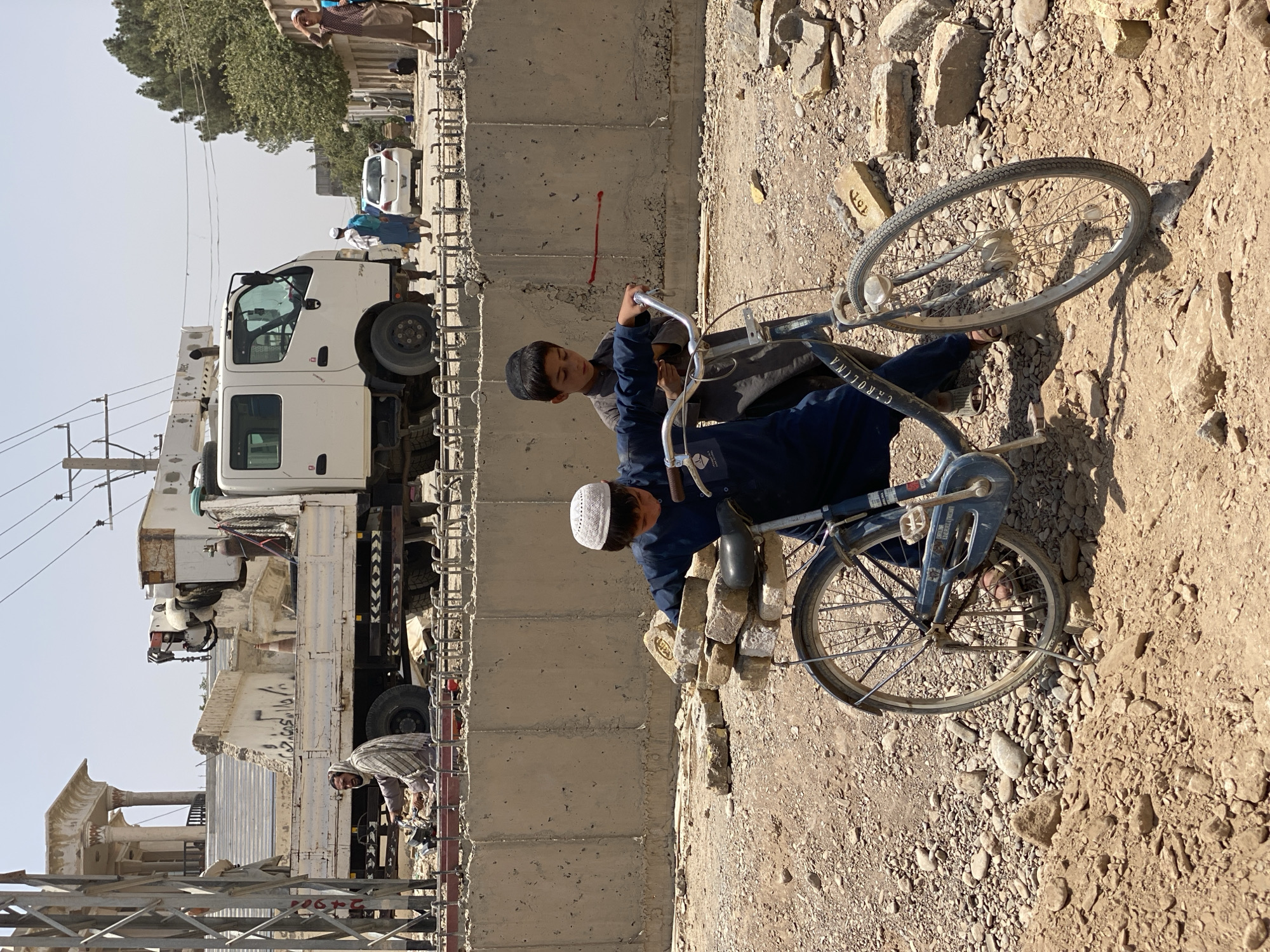 Everyday street life on a dusty Kandahar road