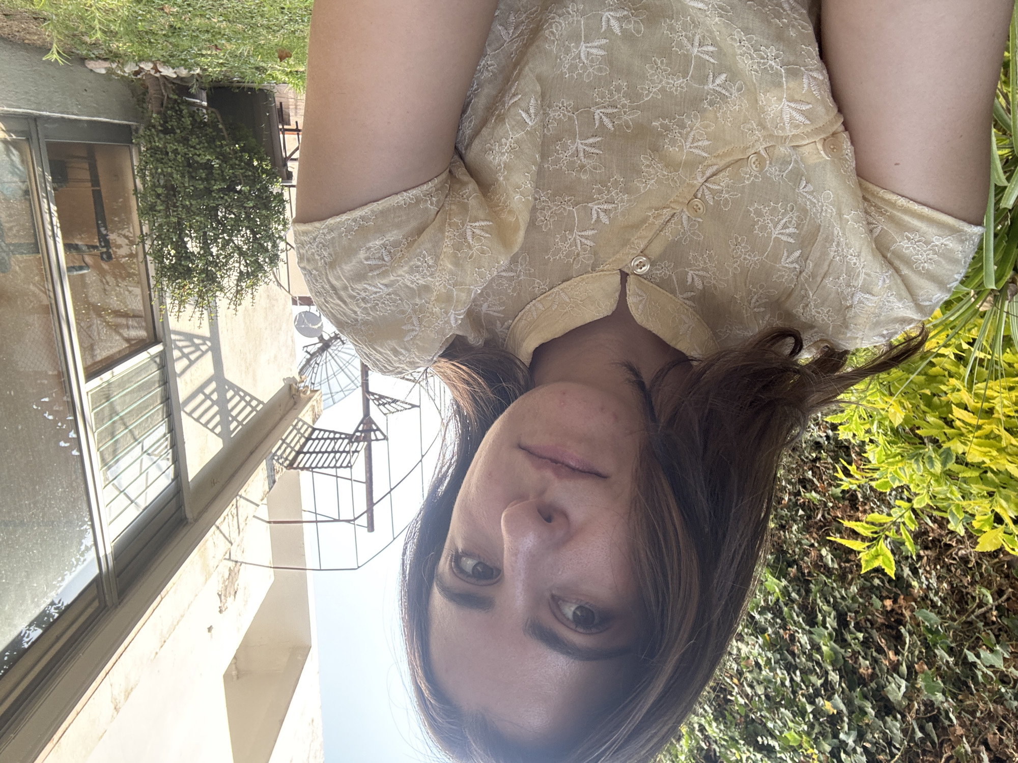 Woman photographed in yellow embroidered blouse in Puebla