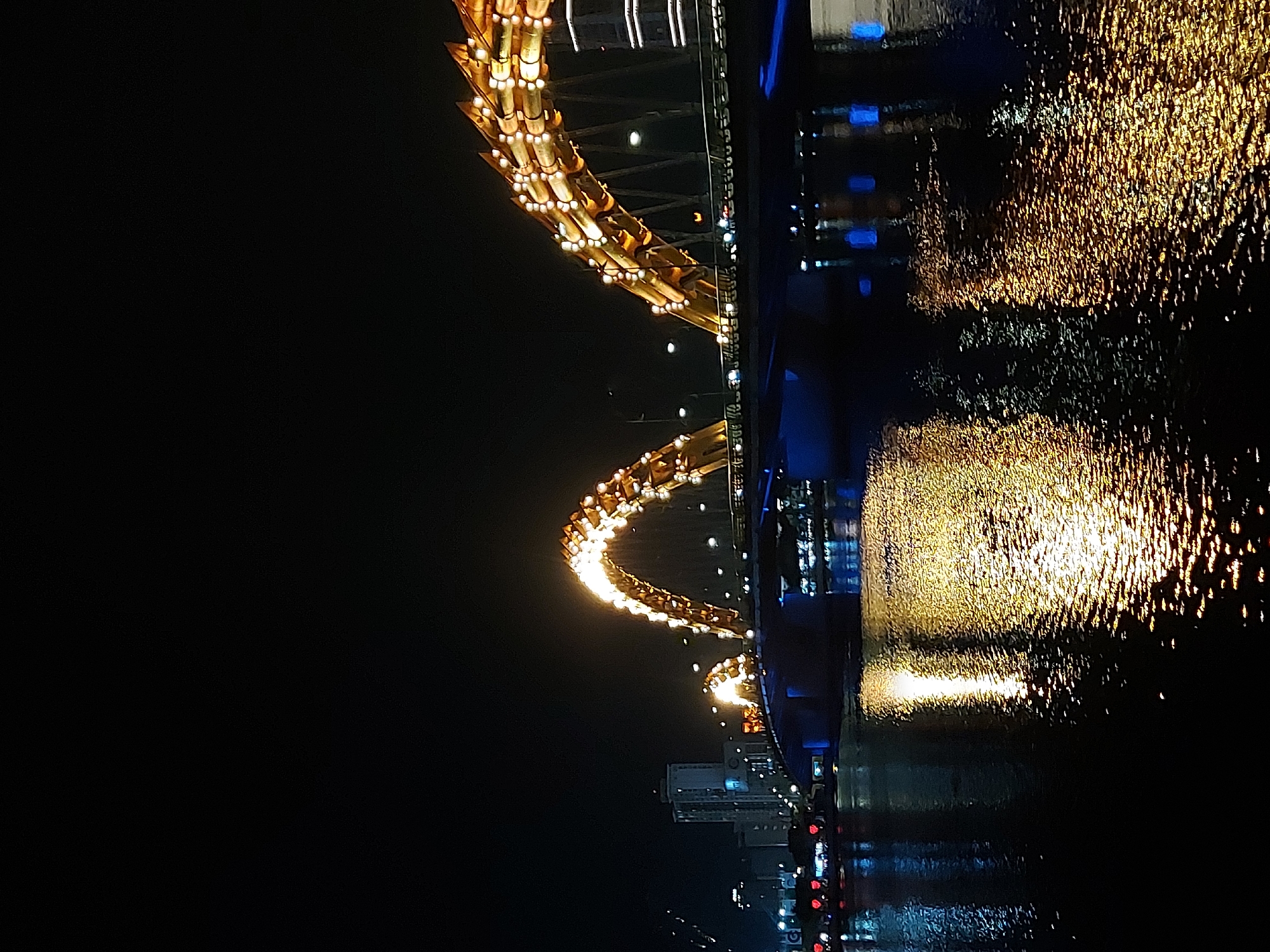 Dragon Bridge glows gold over Da Nang at night