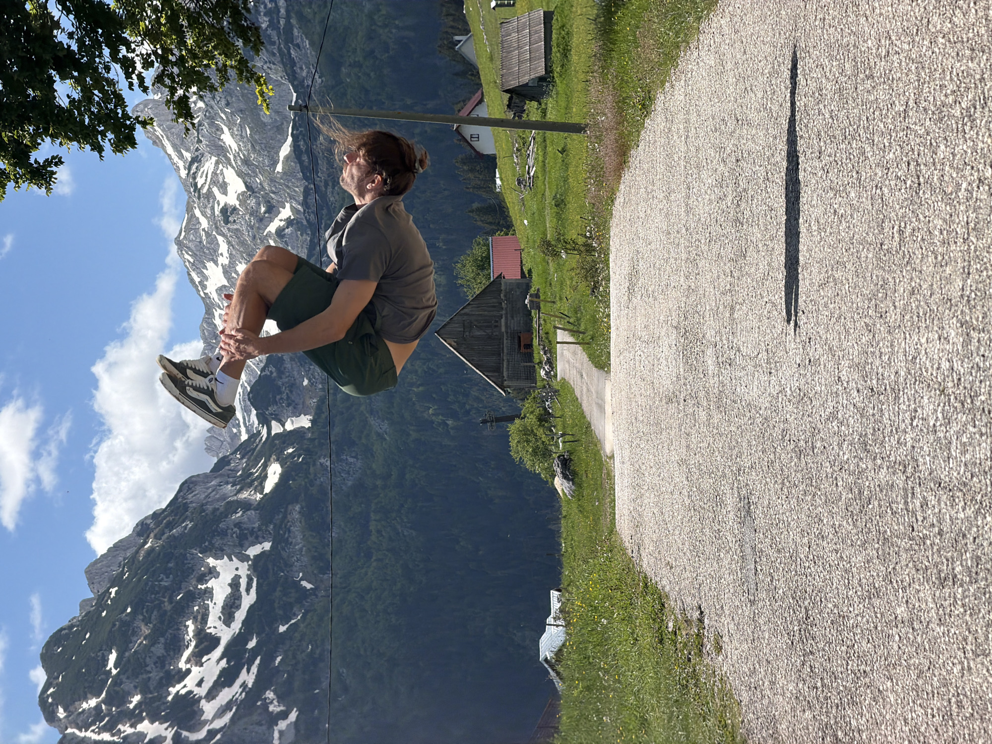 Young man captured mid-leap in Montenegro mountain landscape