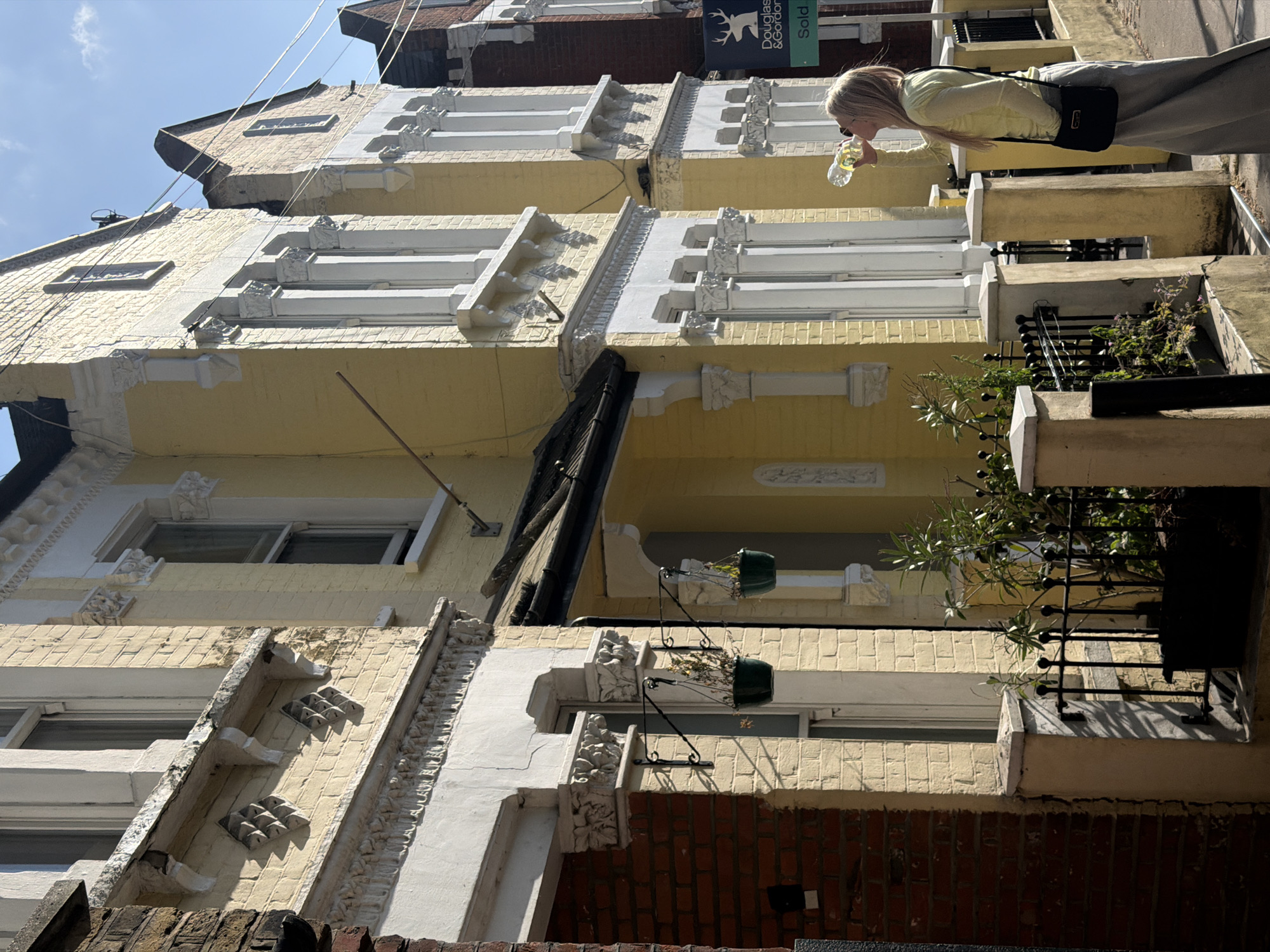 Person spotted on sunny London street amid terraced buildings