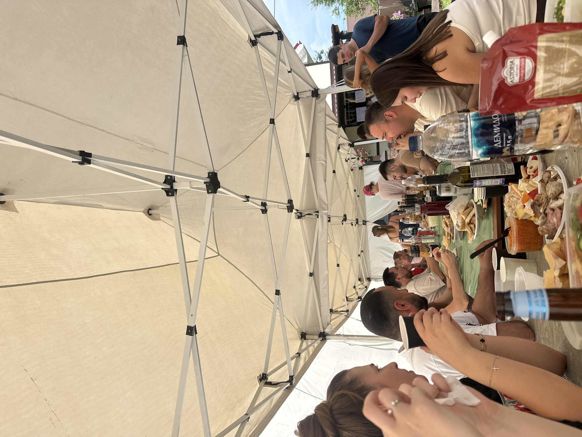 Outdoor feast under a white tent in Sylva, Russia