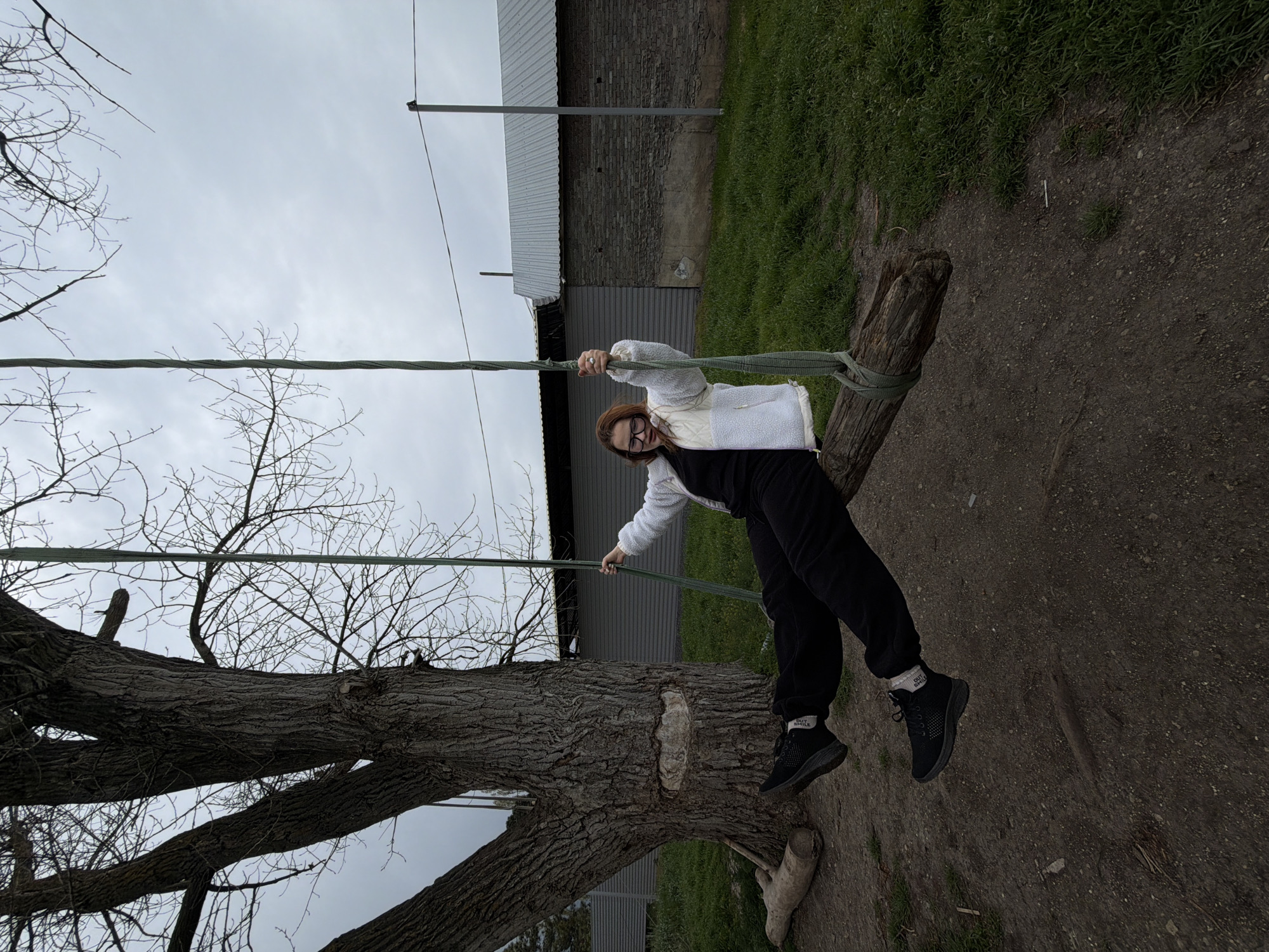 Woman enjoys homemade tree swing in Port-Katon, Russia