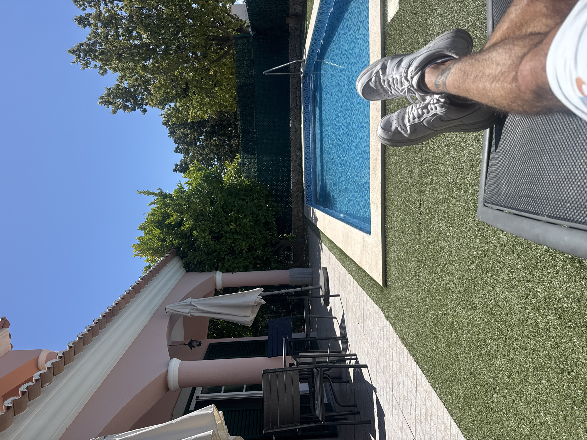 Swimming pool area with pink building observed Tuesday morning