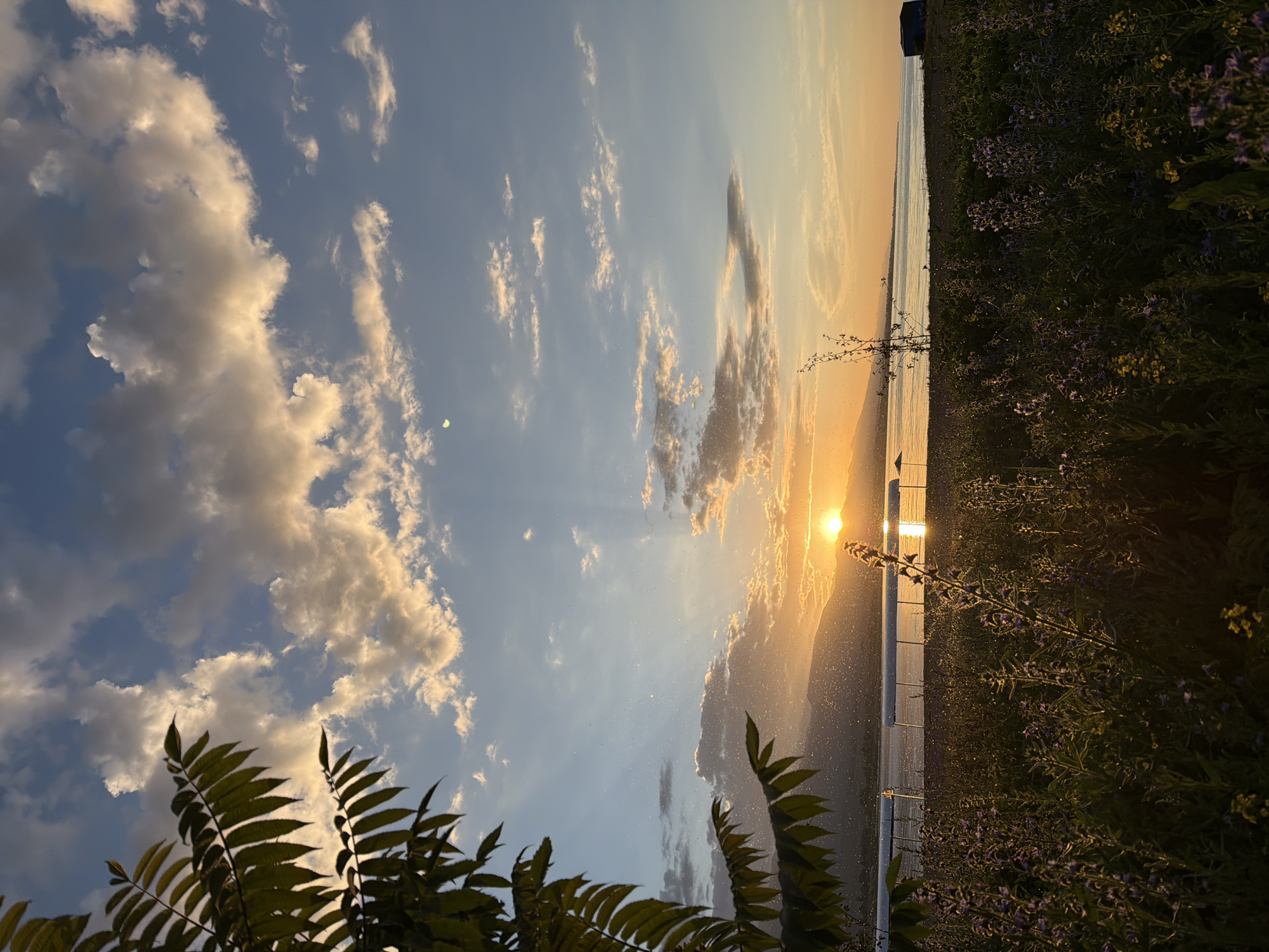 Sunset from a lakeside pier, golden light and quiet water