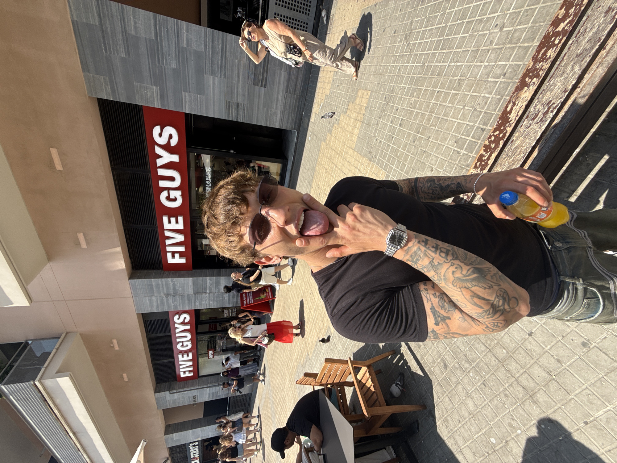 Playful pose with a drink, Barcelona midday