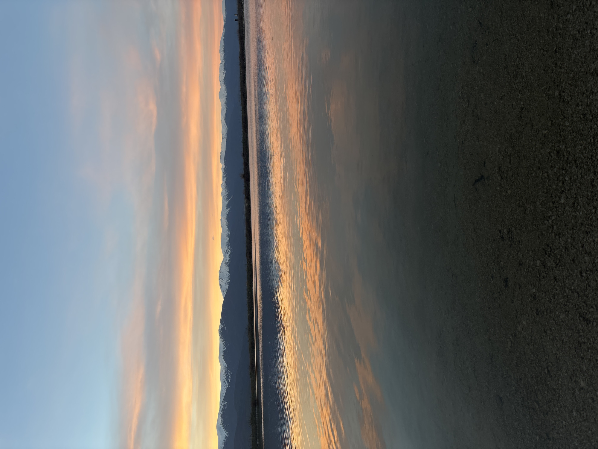 Sunset reflects over water near Dobrinishte, Bulgaria mountains