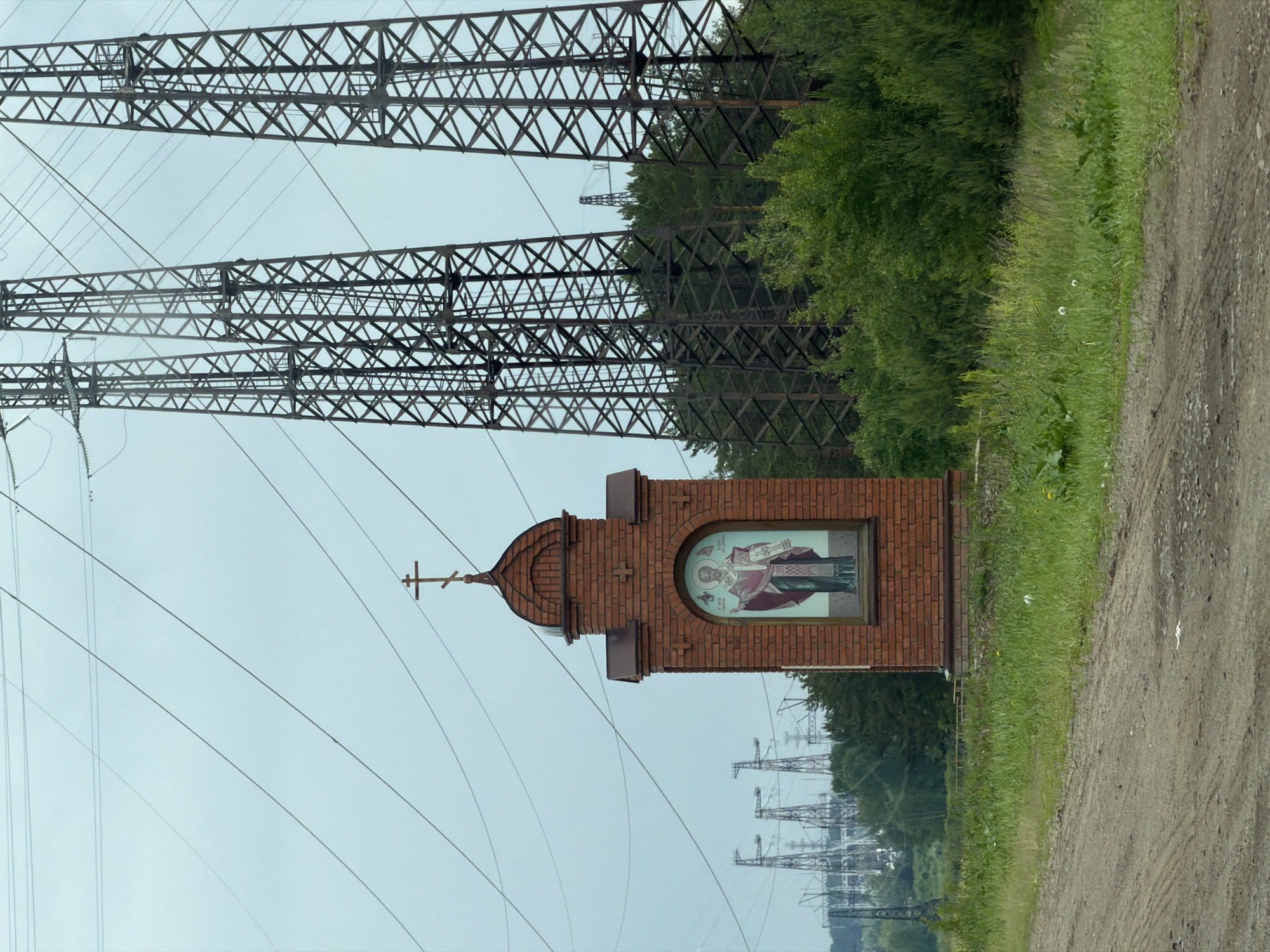Roadside scene with shrine and Lada captured in Noviy, Russia