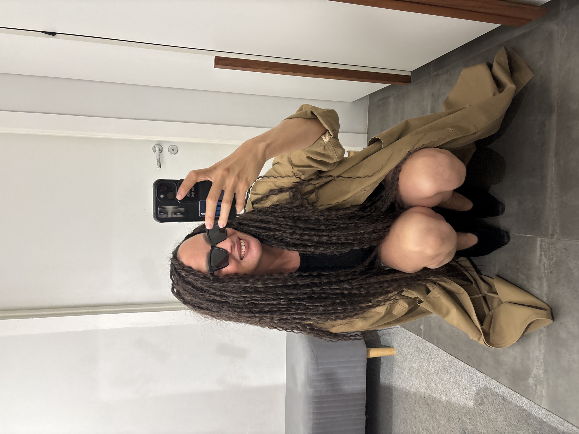 Woman poses with smartphone indoors in Chaikovsky, Russia