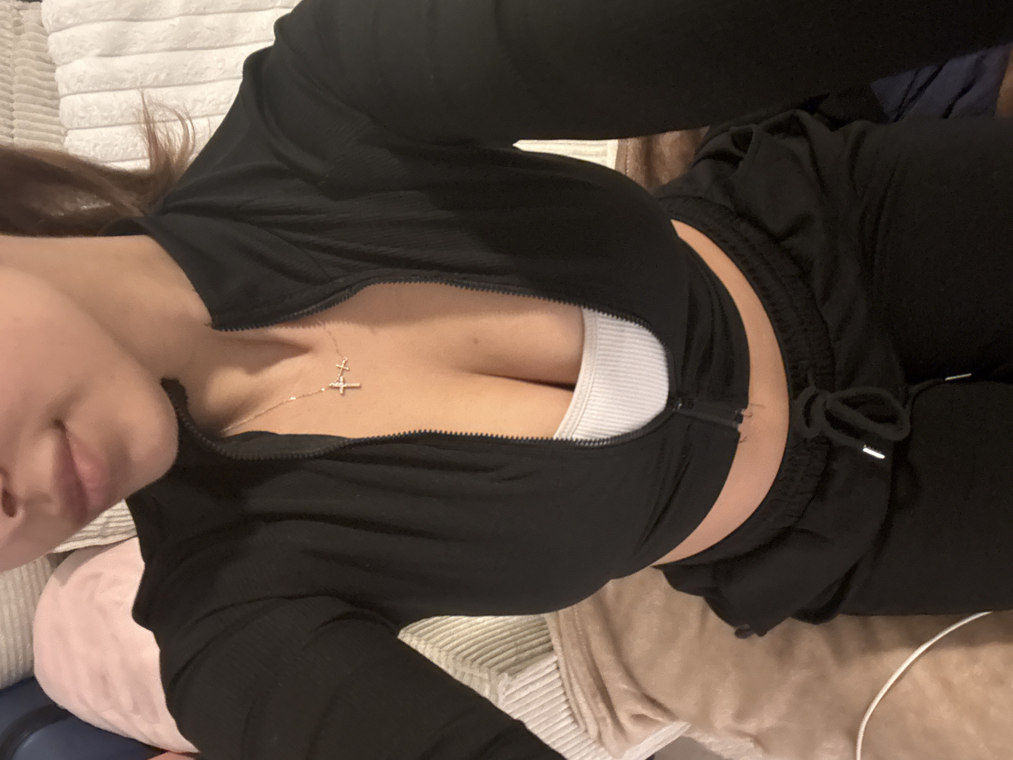 Woman resting indoors in Mönchengladbach wearing casual attire
