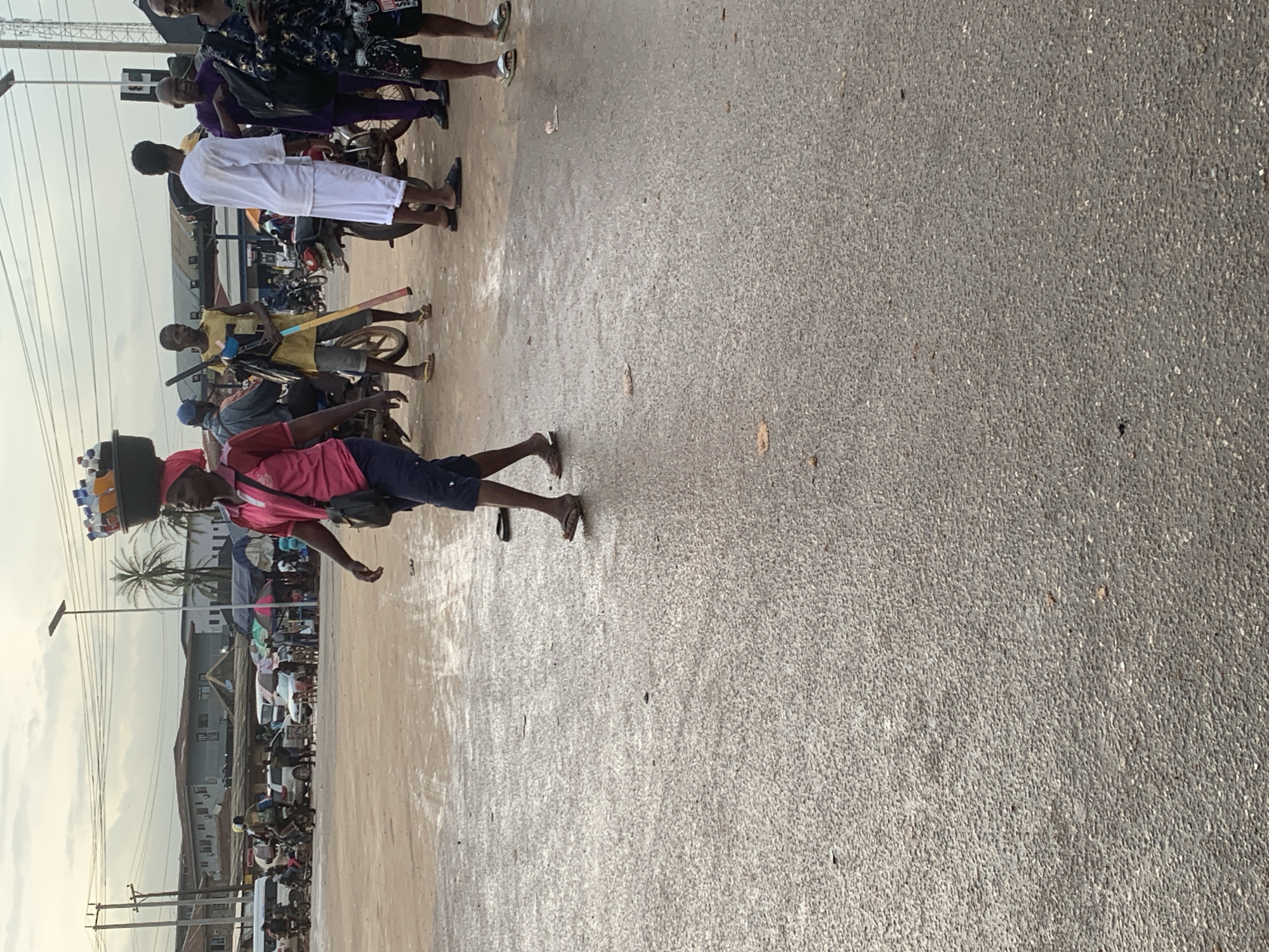 Wet afternoon street life along a Shagamu market thoroughfare