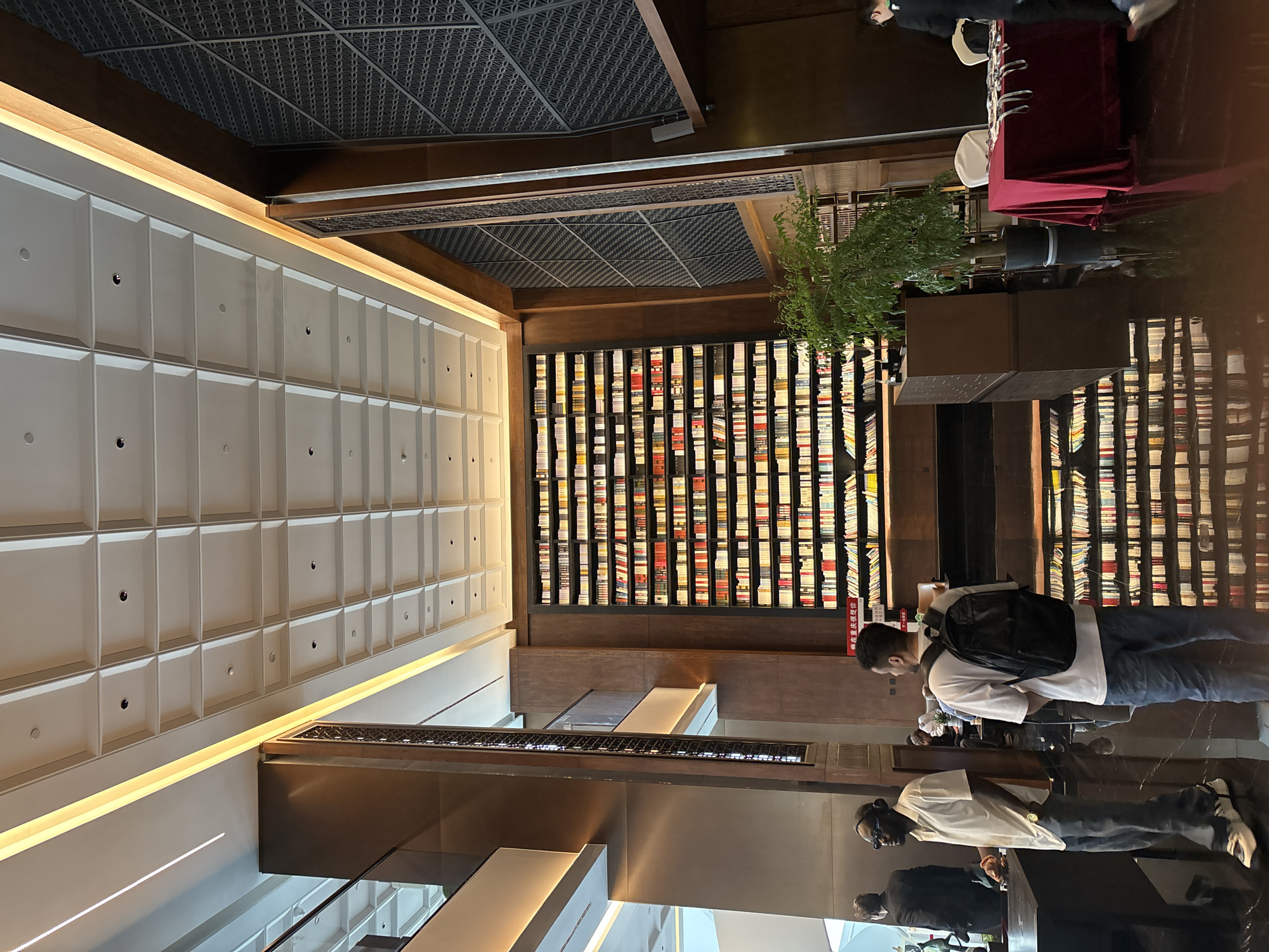 Interior scenes documented at Liangjiang bookstore featuring bronze sculptures