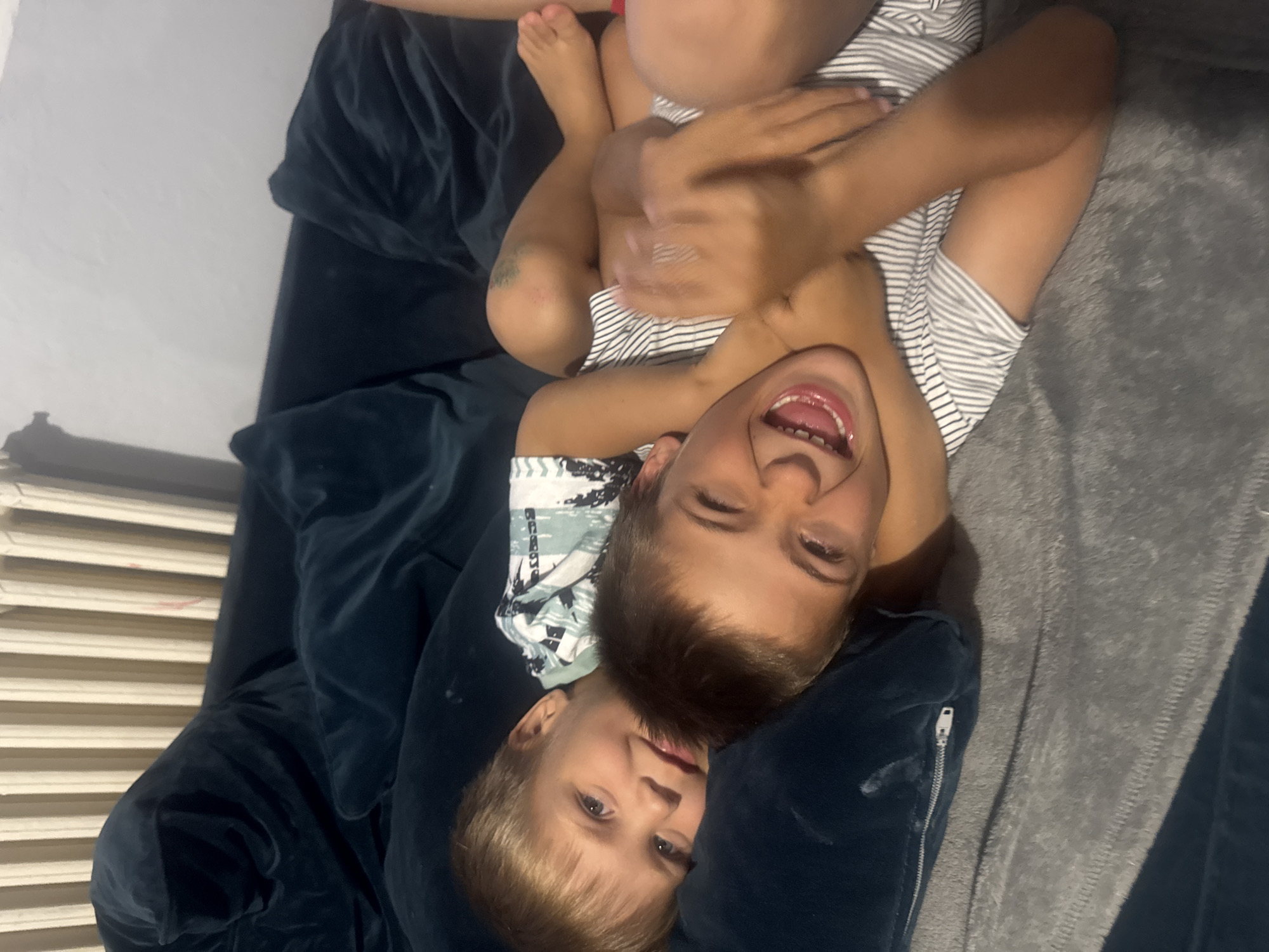 Kids relaxing and playing together on the couch at home