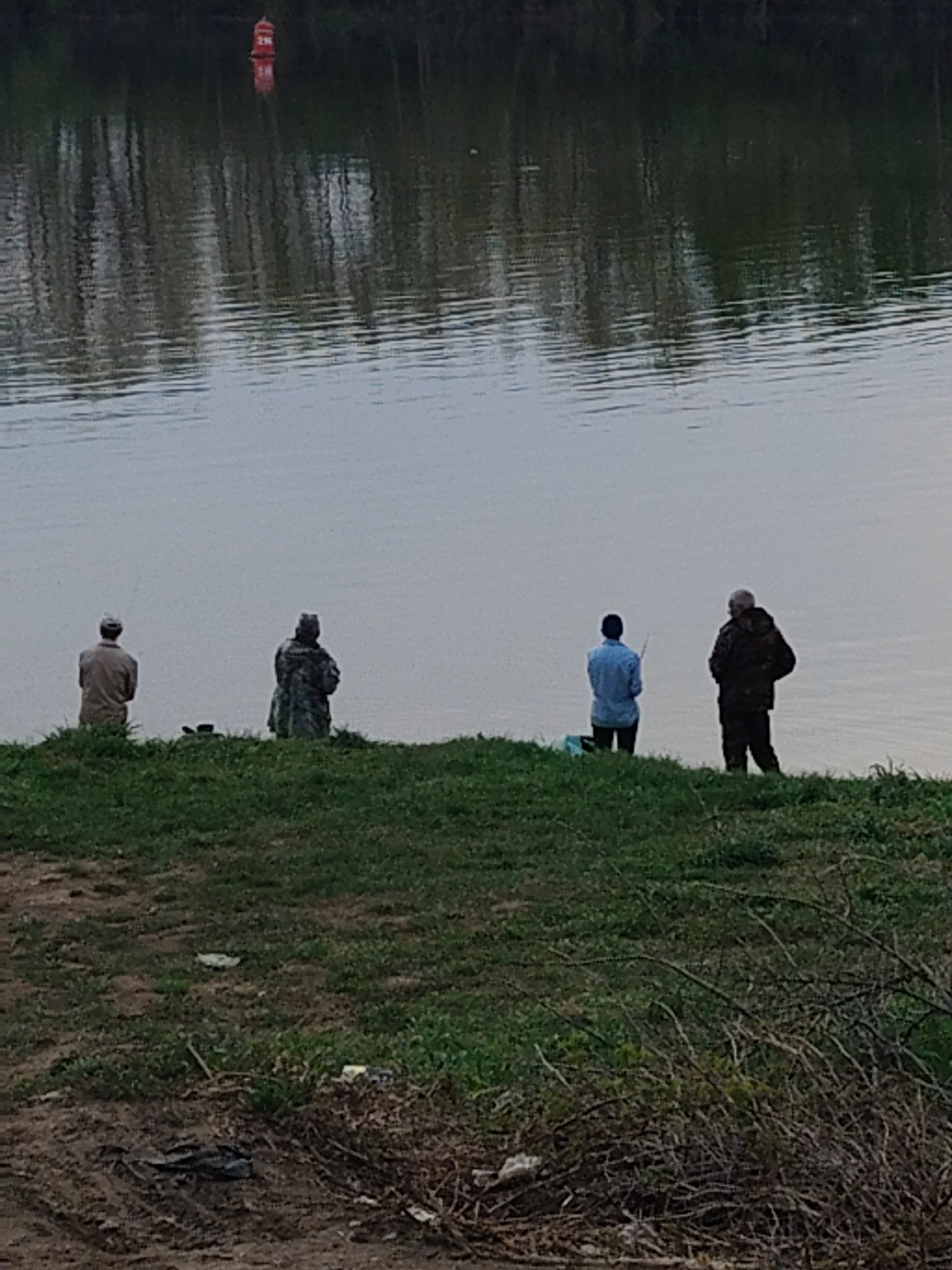 Group fishing along turbulent waterway with mixed terrain