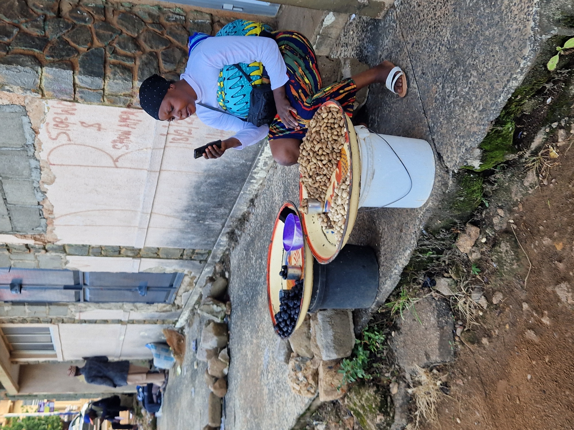 Street-level commerce and foot traffic through Jos market district
