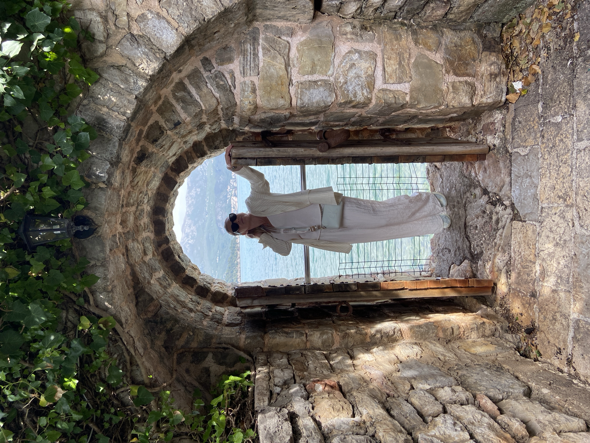 Tourist explores historic Budva Old Town, cafes, coastal views