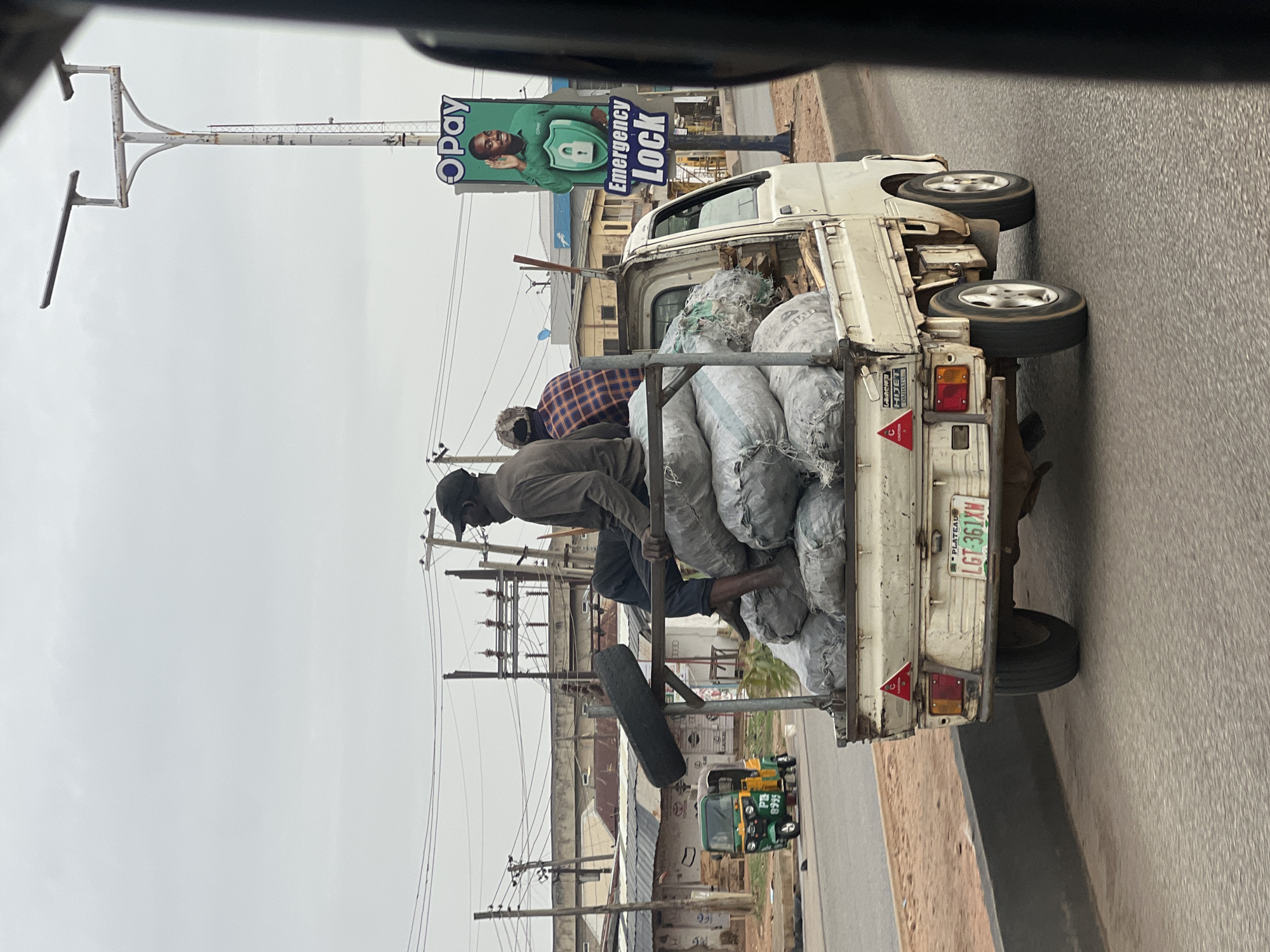 Overloaded truck with passengers travels Nigerian road