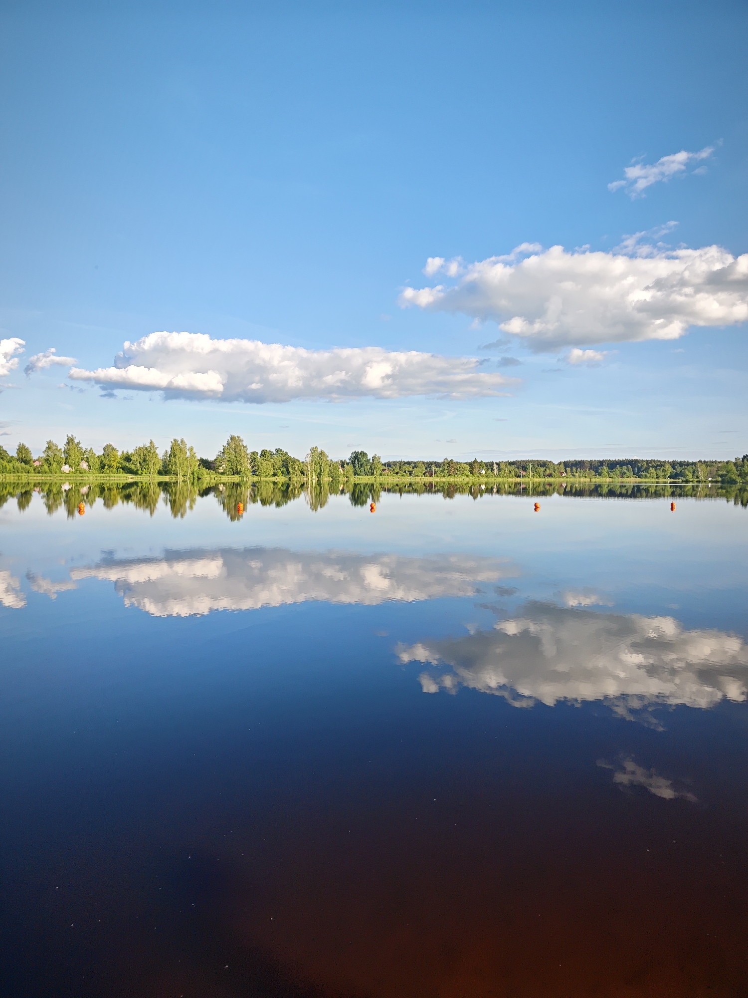 Woman visits waterside park in Zaprudnya during golden hour