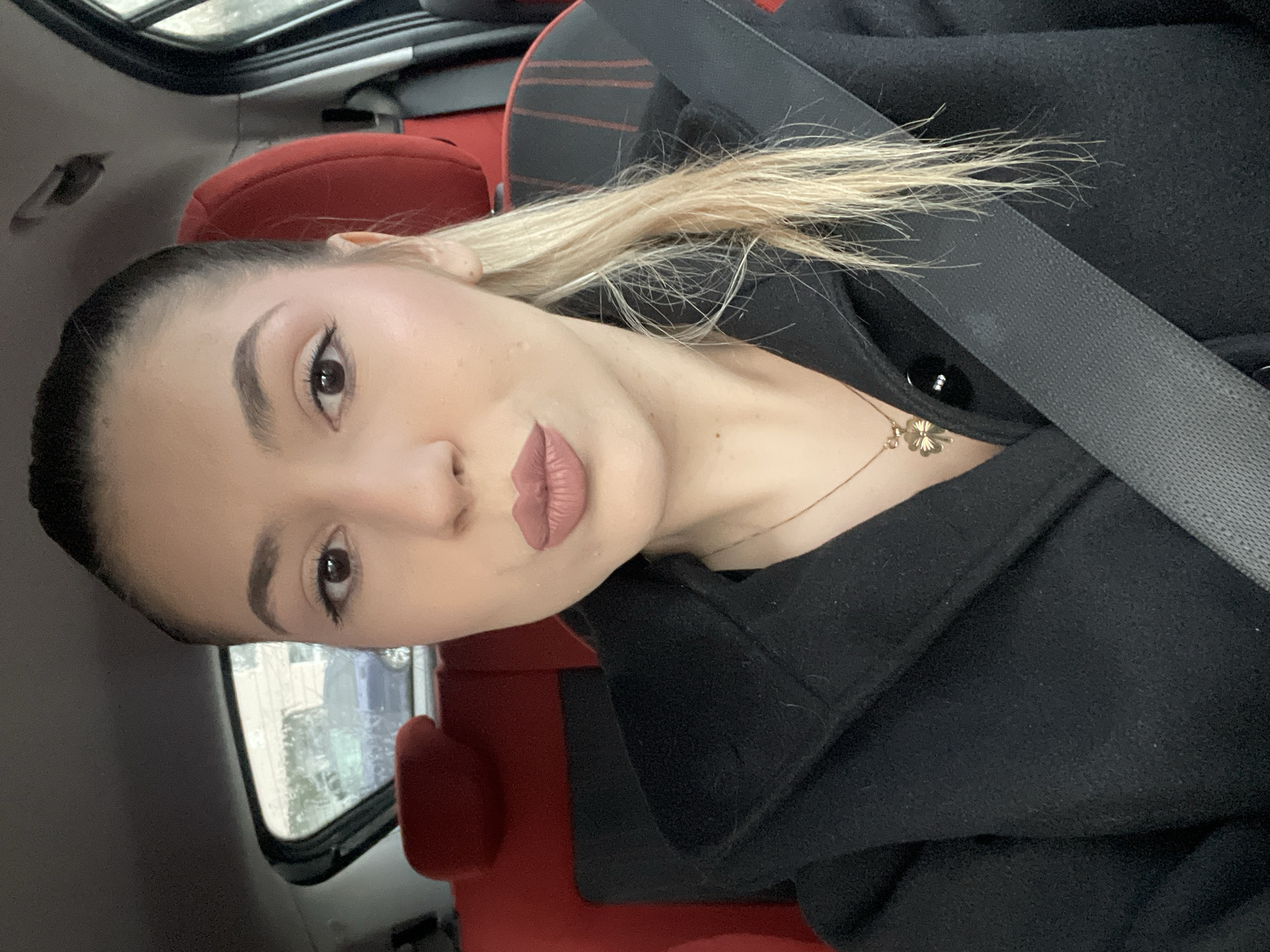 Woman takes selfie in parked car in Burgas, Bulgaria