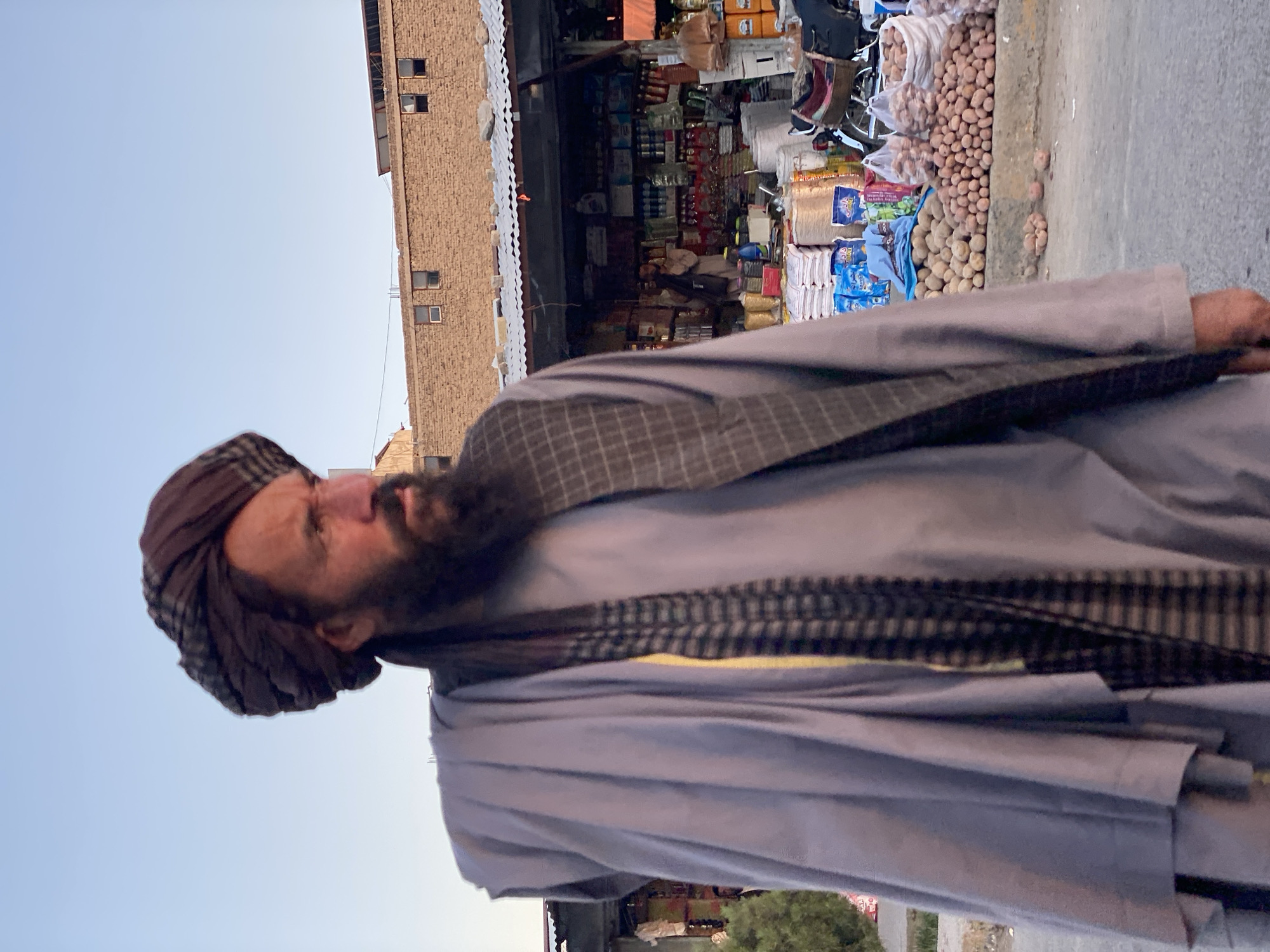 Kandahar street market: watermelon vendors, foot traffic, afternoon light