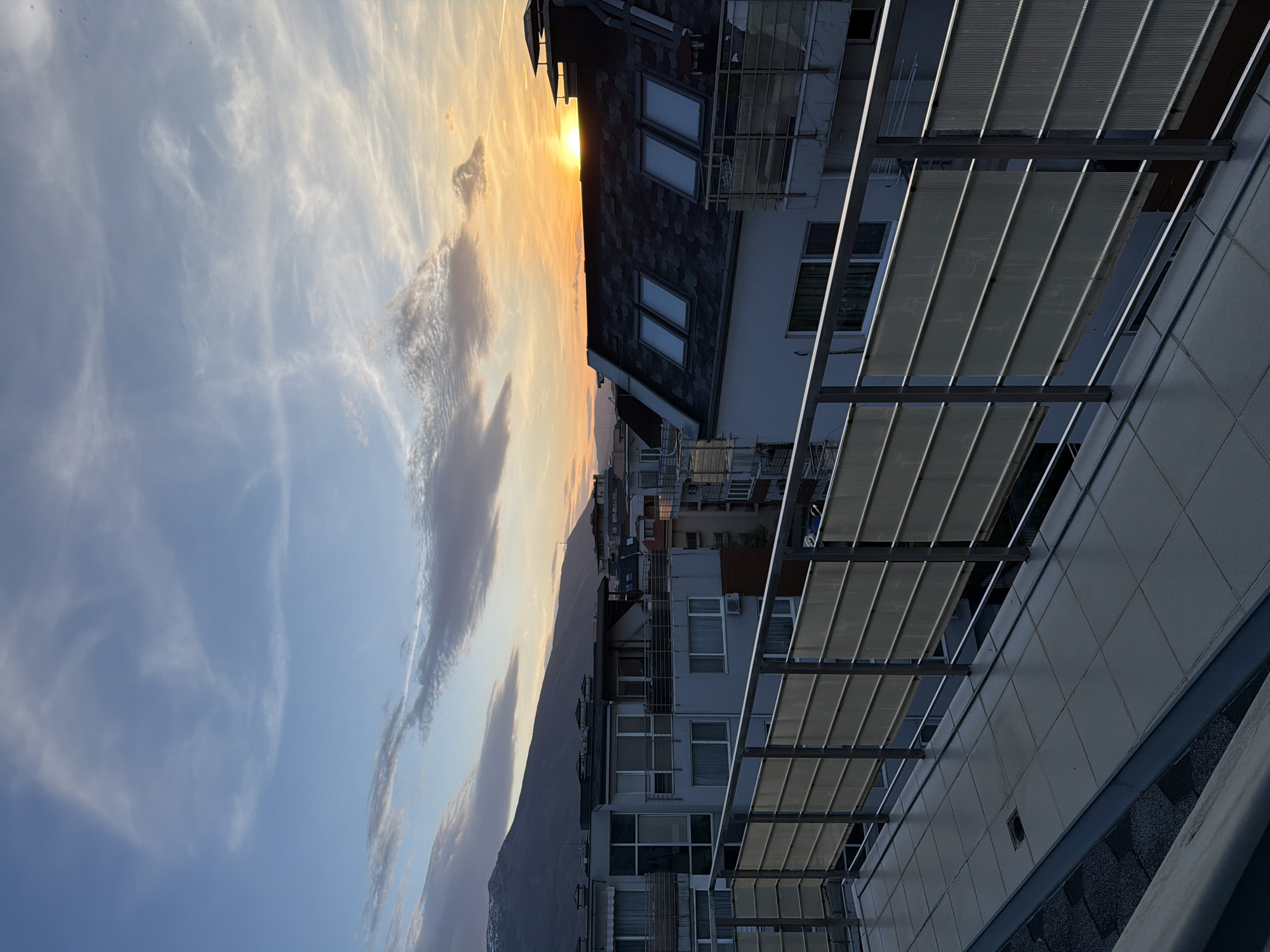Dramatic sunset captured over Sofia skyline from rooftop