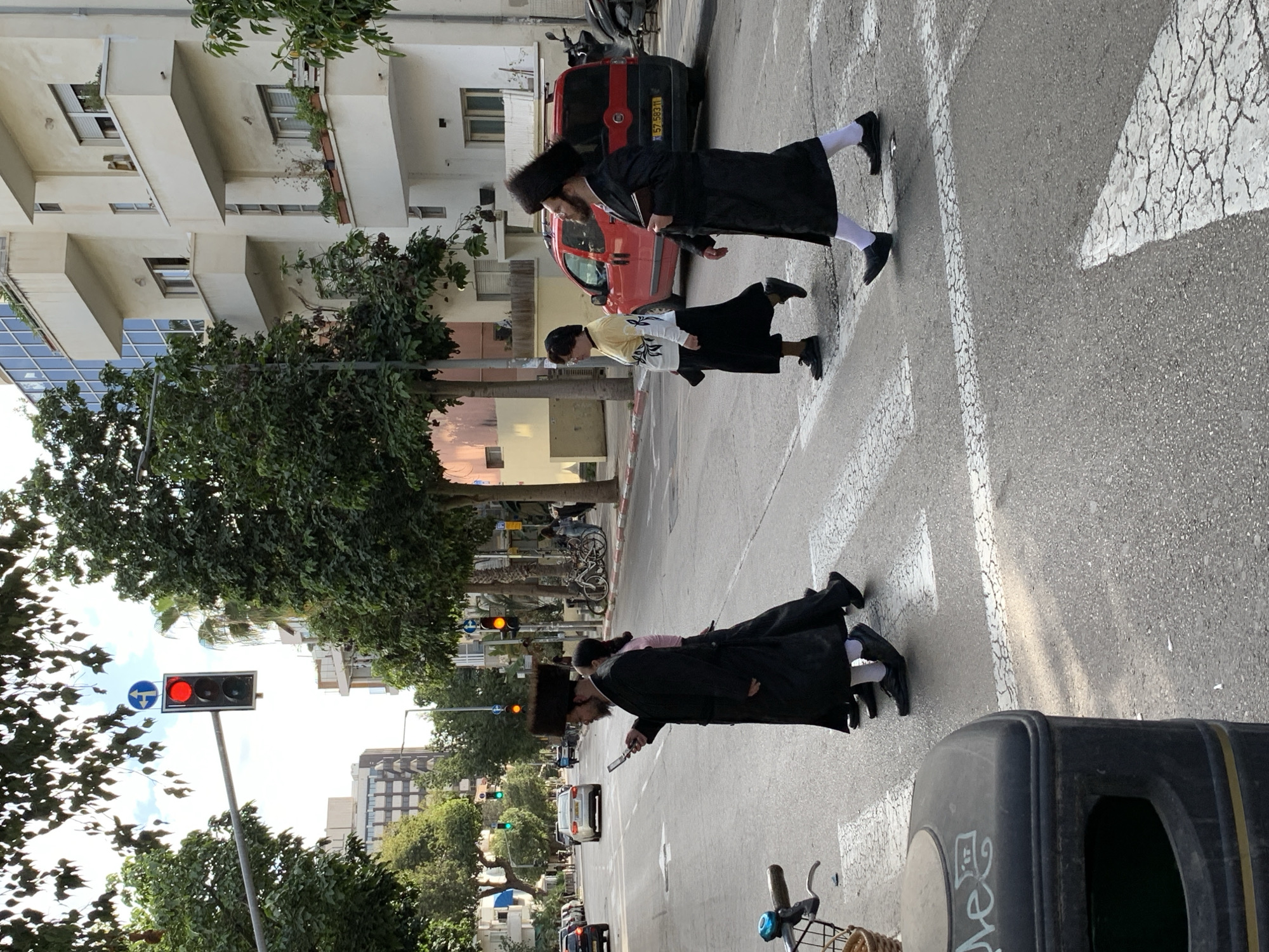 Orthodox men cross Tel Aviv street in everyday scene