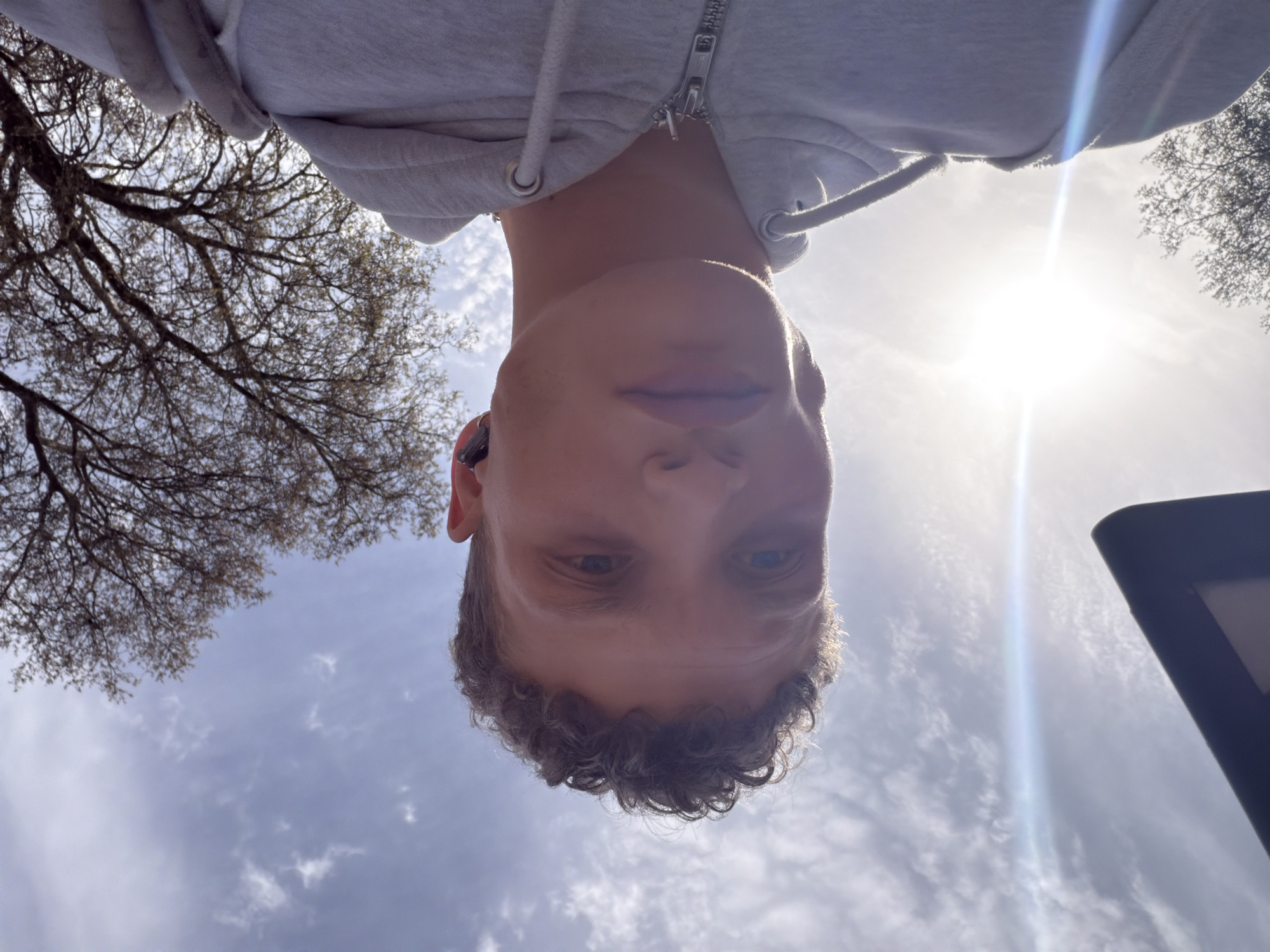 Upward photo captures young person looking down in London