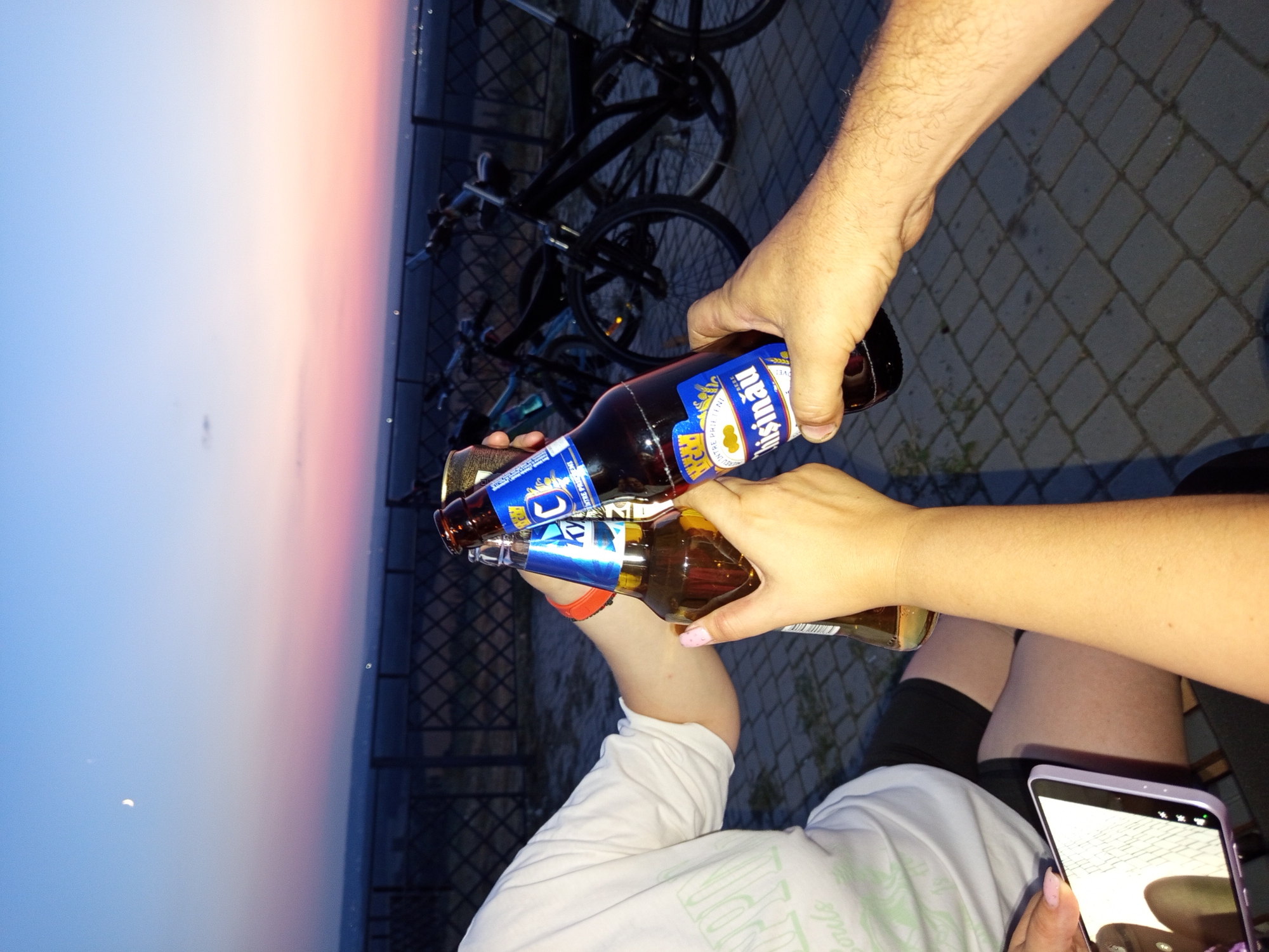 Dusk toast with bikes parked nearby under a crescent moon