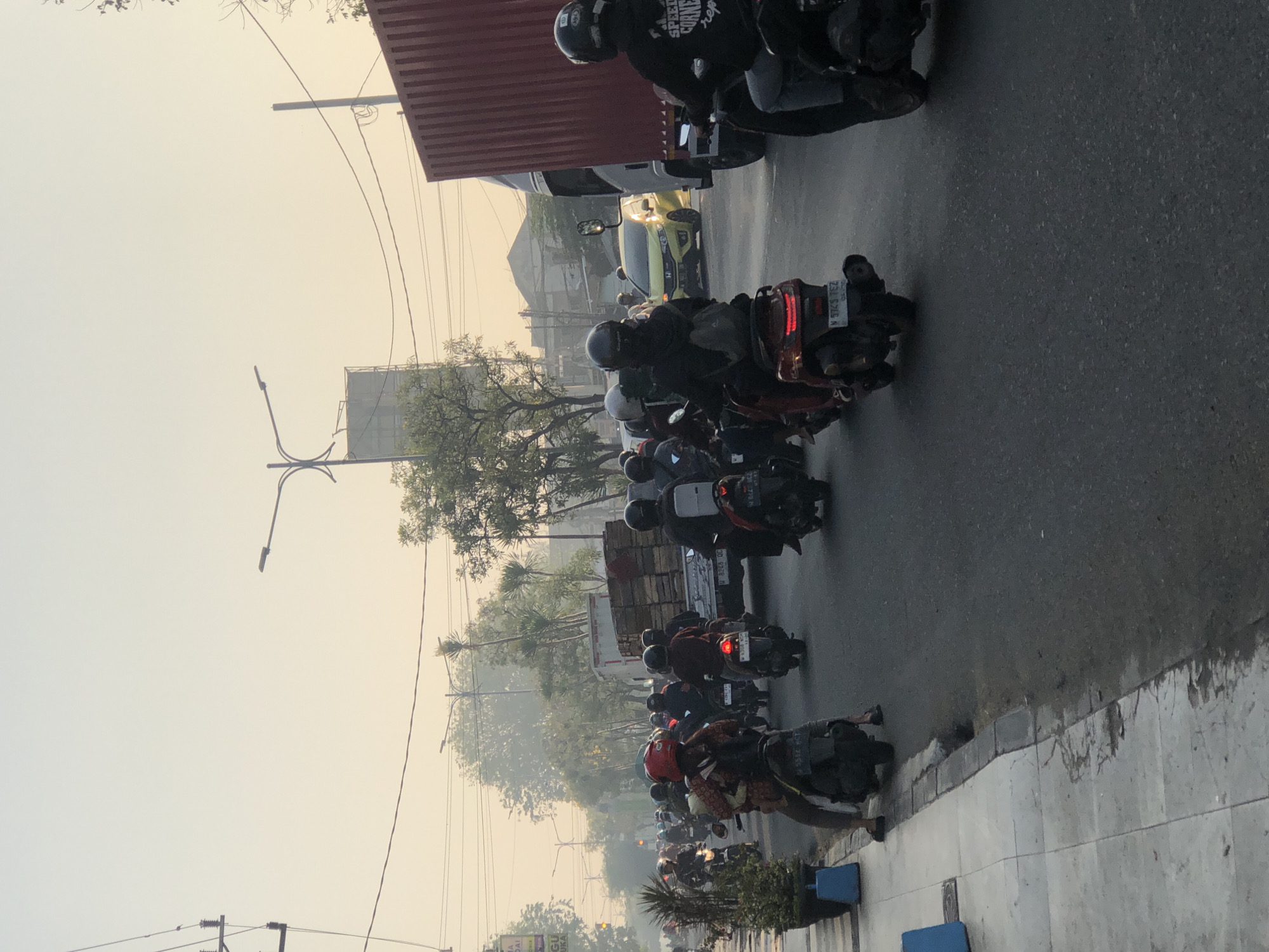 Kludan's hazy morning commute, motorcycles wall to wall