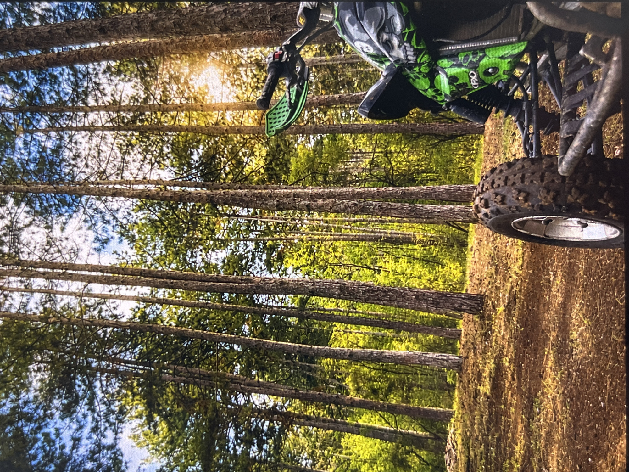 ATV and reflective table documented in wooded outdoor setting