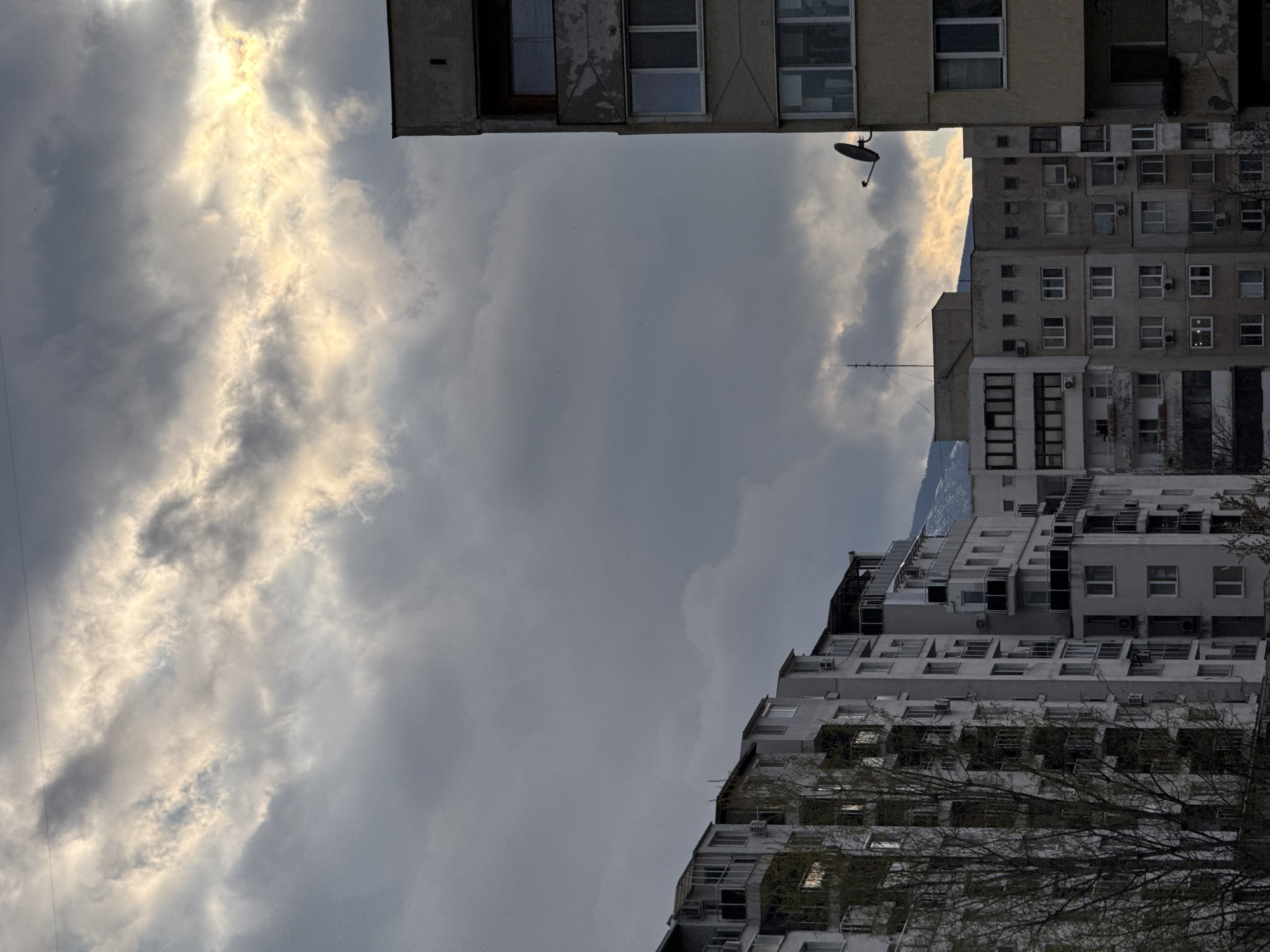 Cloudy sky viewed between Soviet-era apartments in Sofia