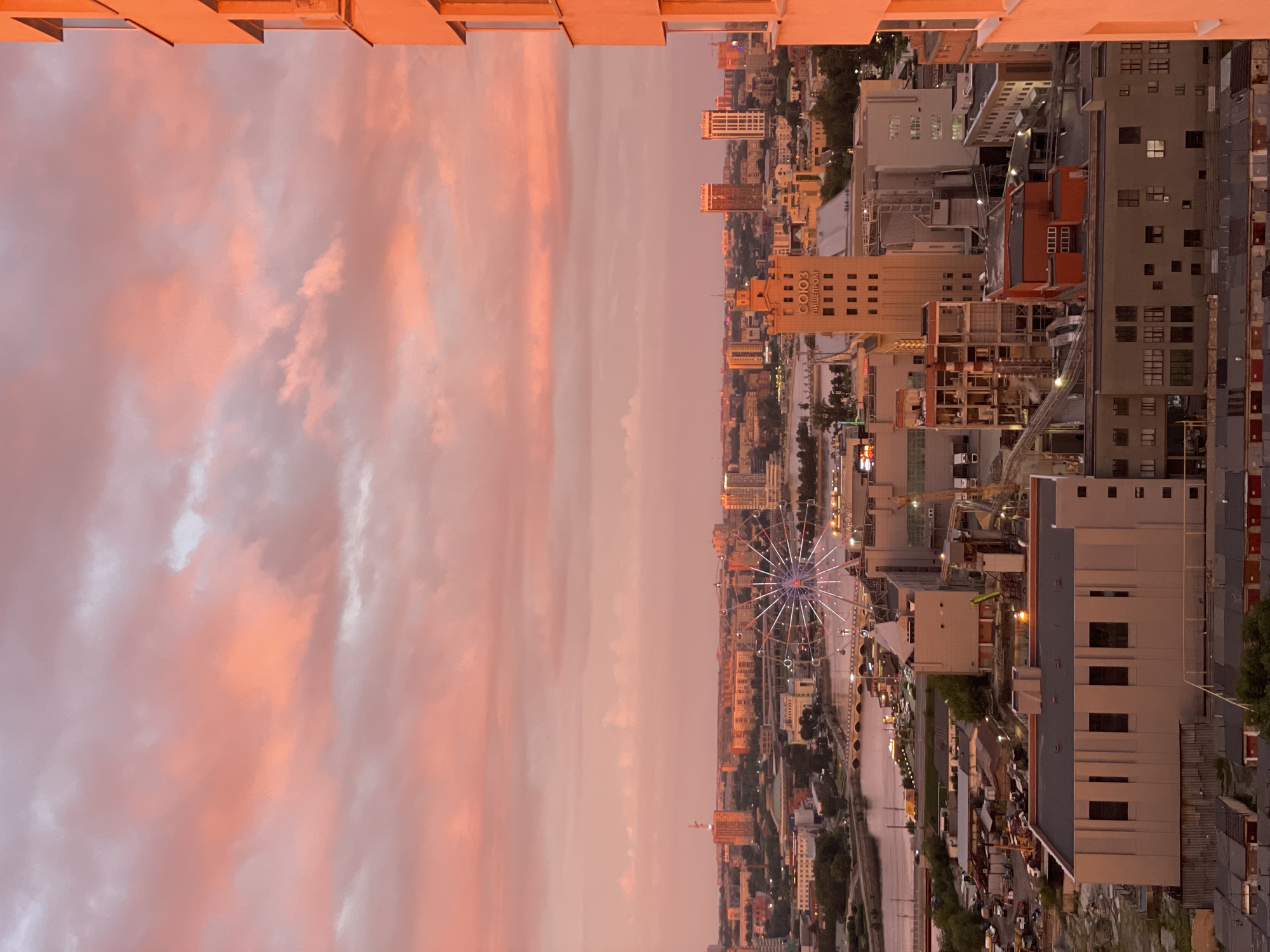 Sunset rainbow over a dense city skyline