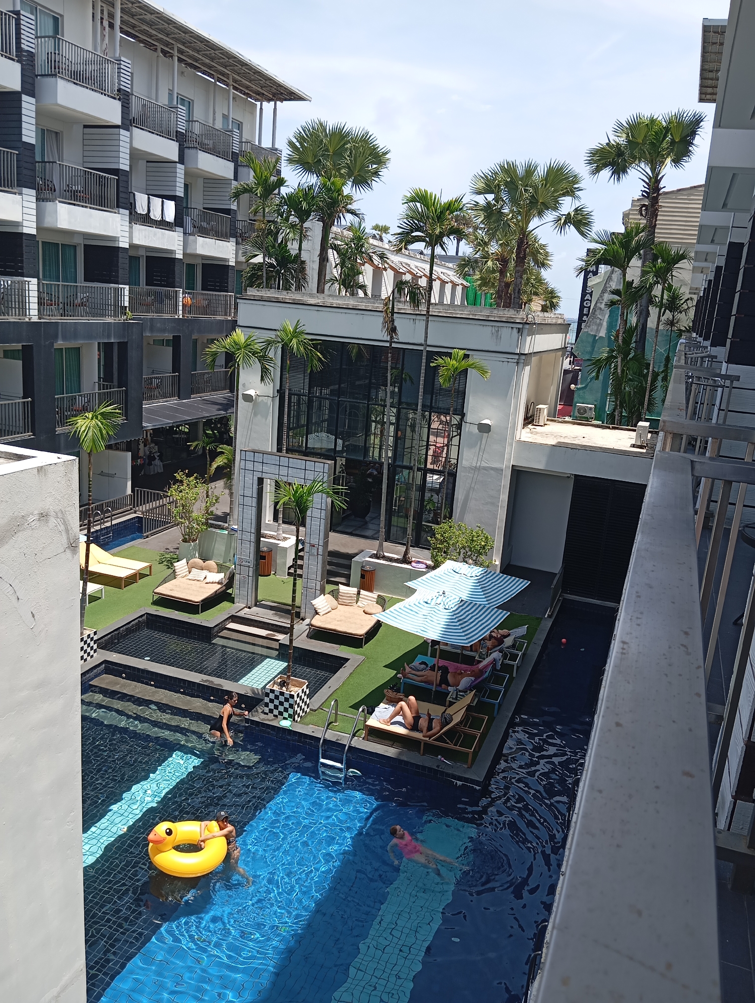 Karon hillsides, poolside courtyards, and a hilltop Buddha
