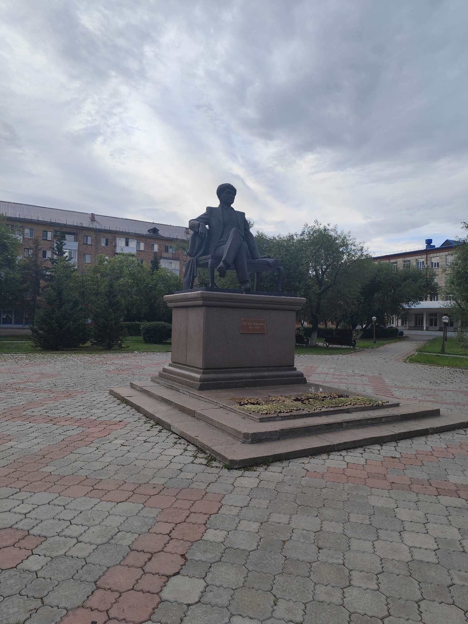 Urban streetscape with statues, apartment blocks, and public spaces