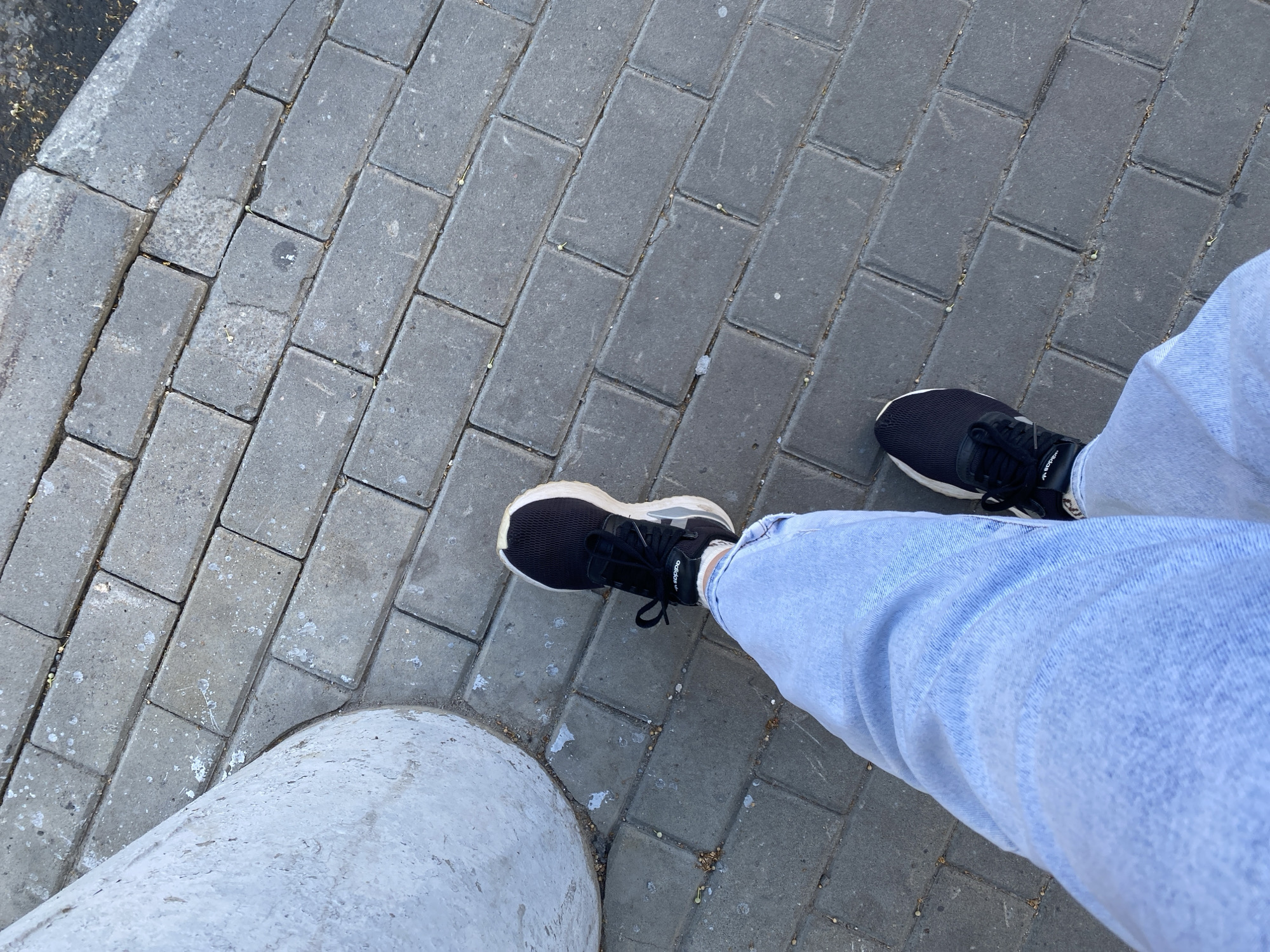 Standing on gray brick pavement in Novaya Usman